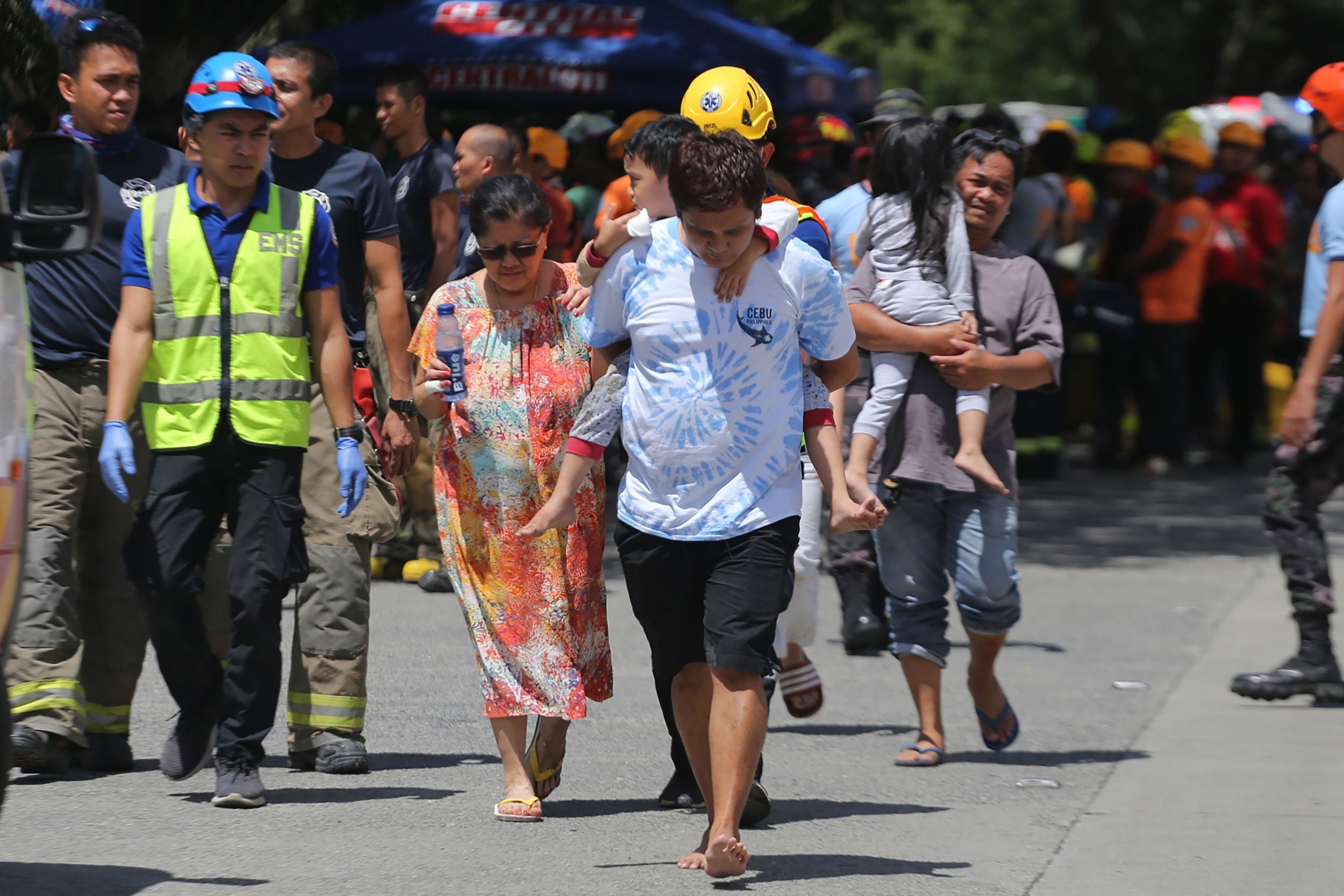 Residents are evacuated from a damaged building after a major earthquake hit Davao City in the southern island of Mindanao