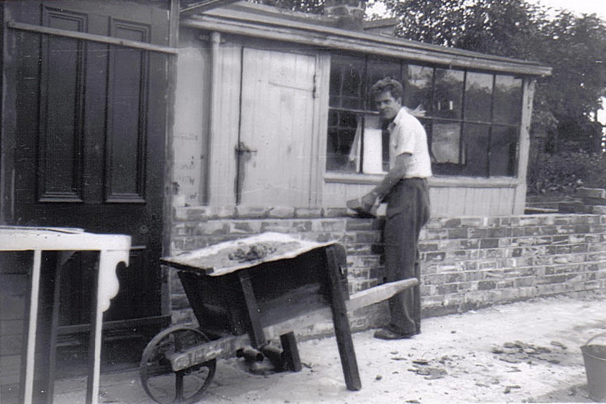 My grandpa building a wall in the back garden