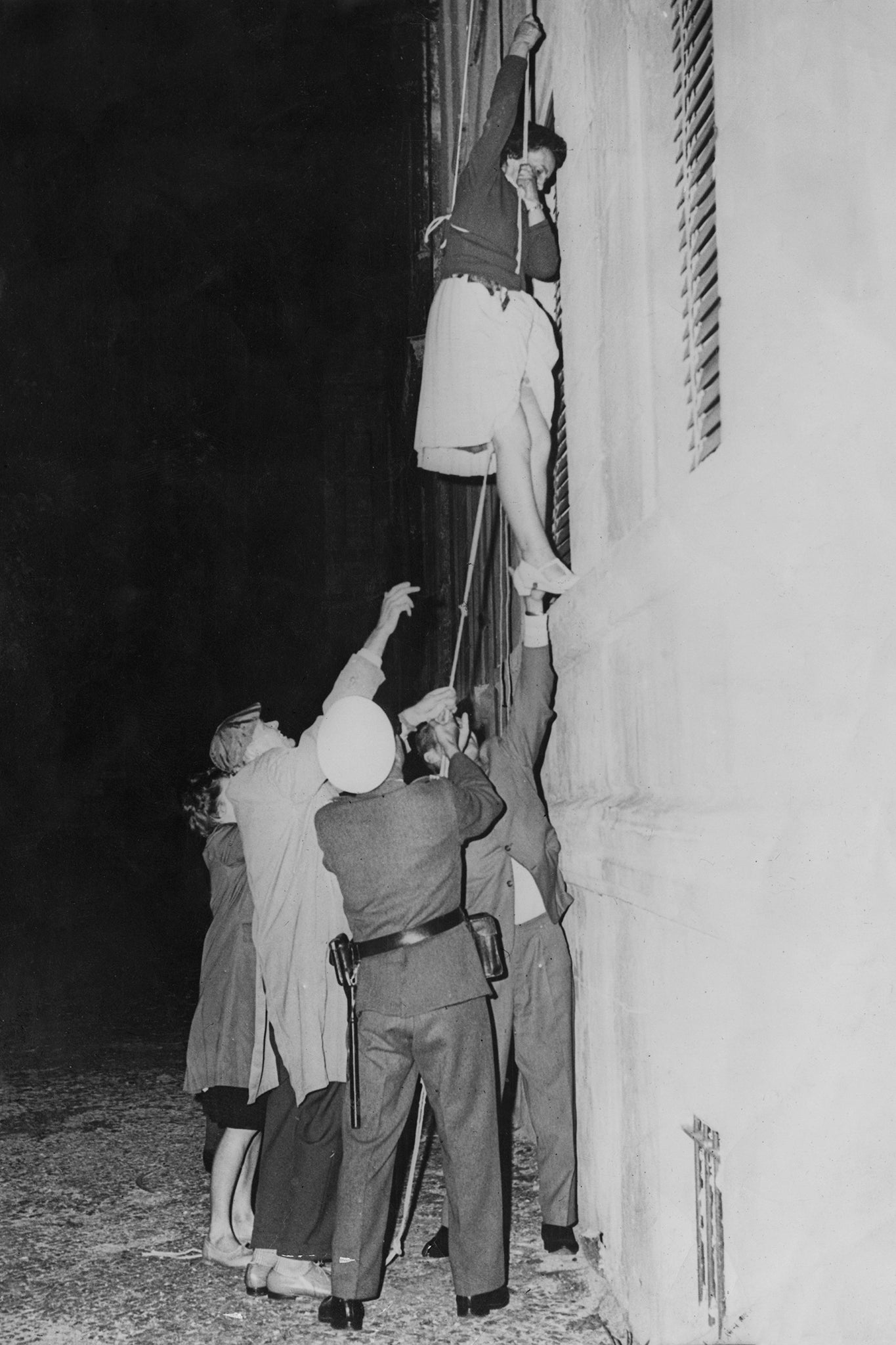 A woman makes her escape through a window into the western sector of Berlin after the post-war division of the city