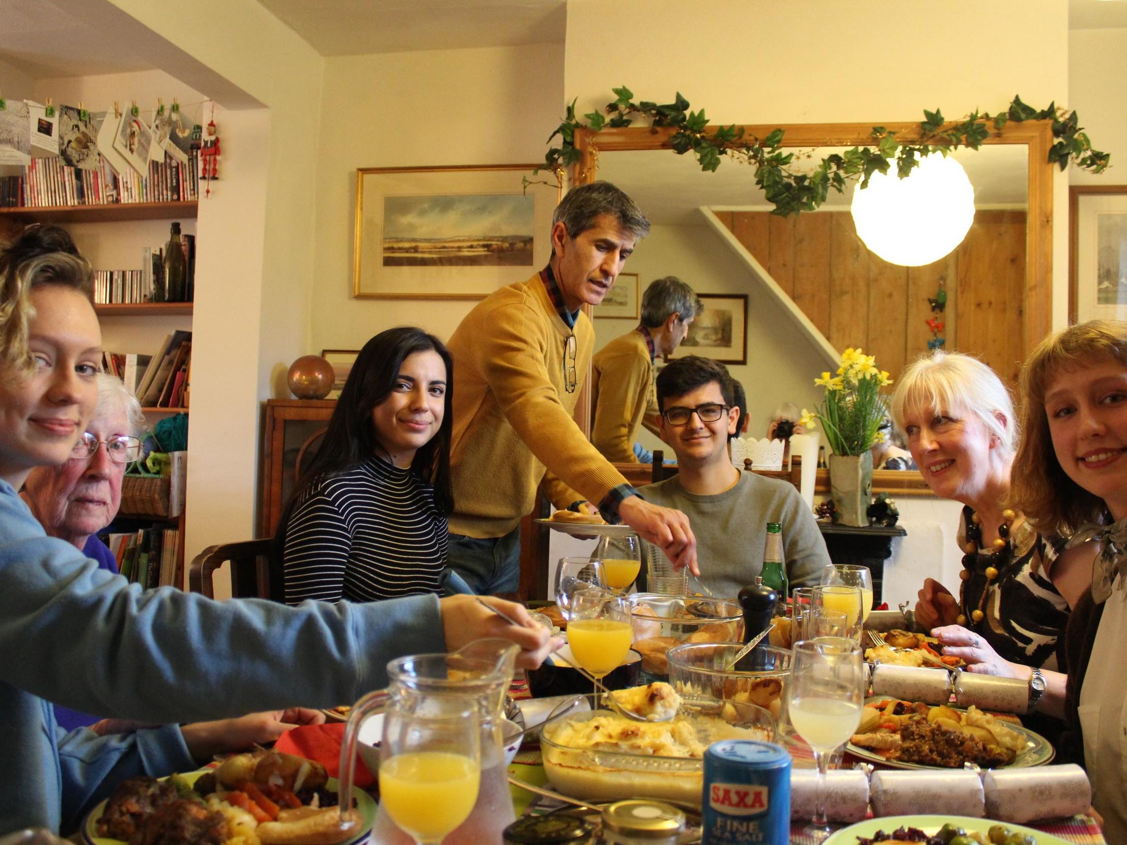 Jane Ruessmann banned presents two years ago and says Christmas has been much more relaxing since. Pictured is Jane's family on Christmas Day with her two daughters, Paula (left) and Jo (right) in the foreground