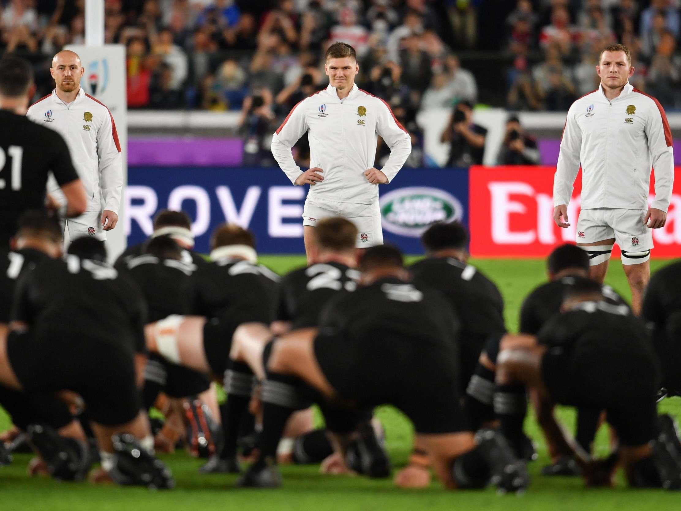 Owen Farrell smiles while the All Blacks perform the Haka