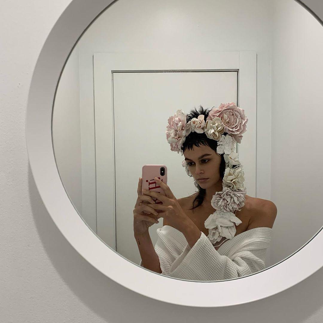 The model wore a floral headdress and an off-the-shoulder white gown for her ghost-inspired look.