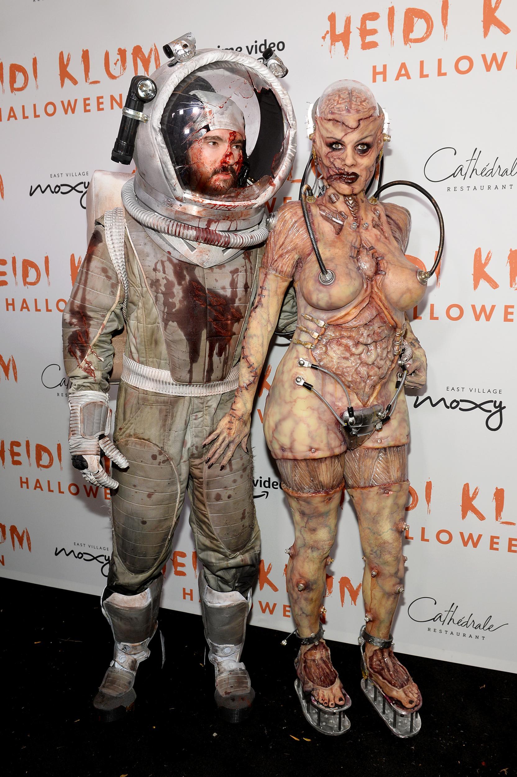 Heidi Klum and her husband, Tom Kaulitz, dressed as an alien and injured astronaut for the model's Halloween party (Getty Images)