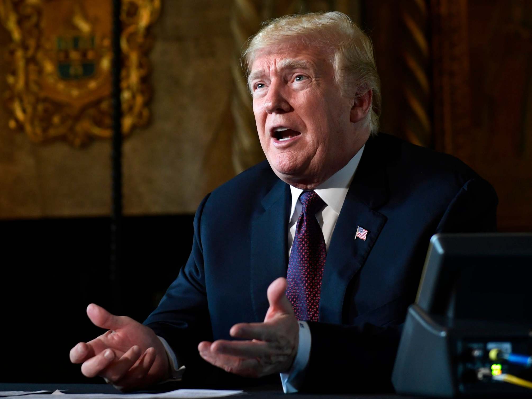 Donald Trump speaks to reporters following a teleconference with troops from his Mar-a-Lago estate in Palm Beach