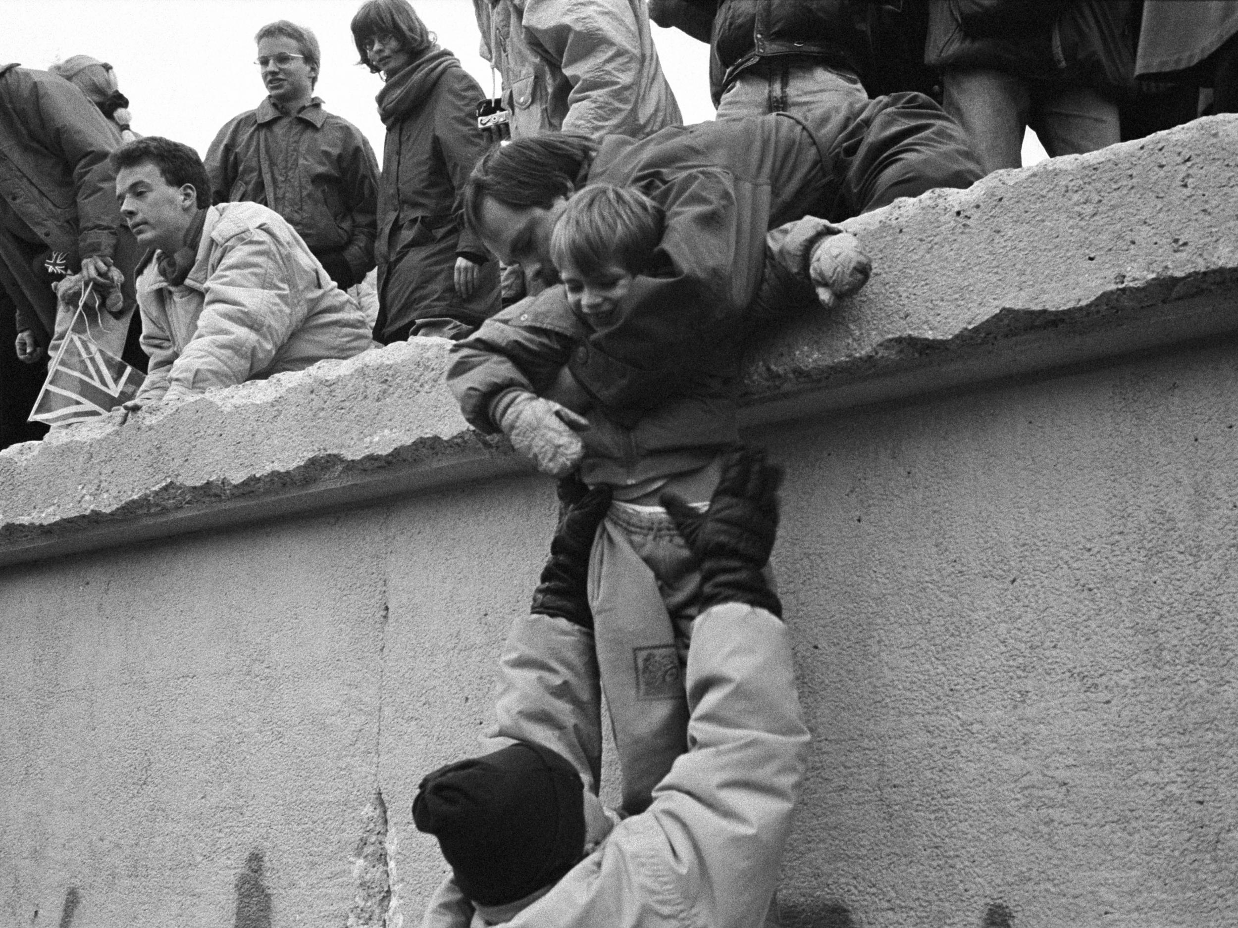 East Berliners climb onto the wall to celebrate the effective end of the city’s partition on 31 December 1989