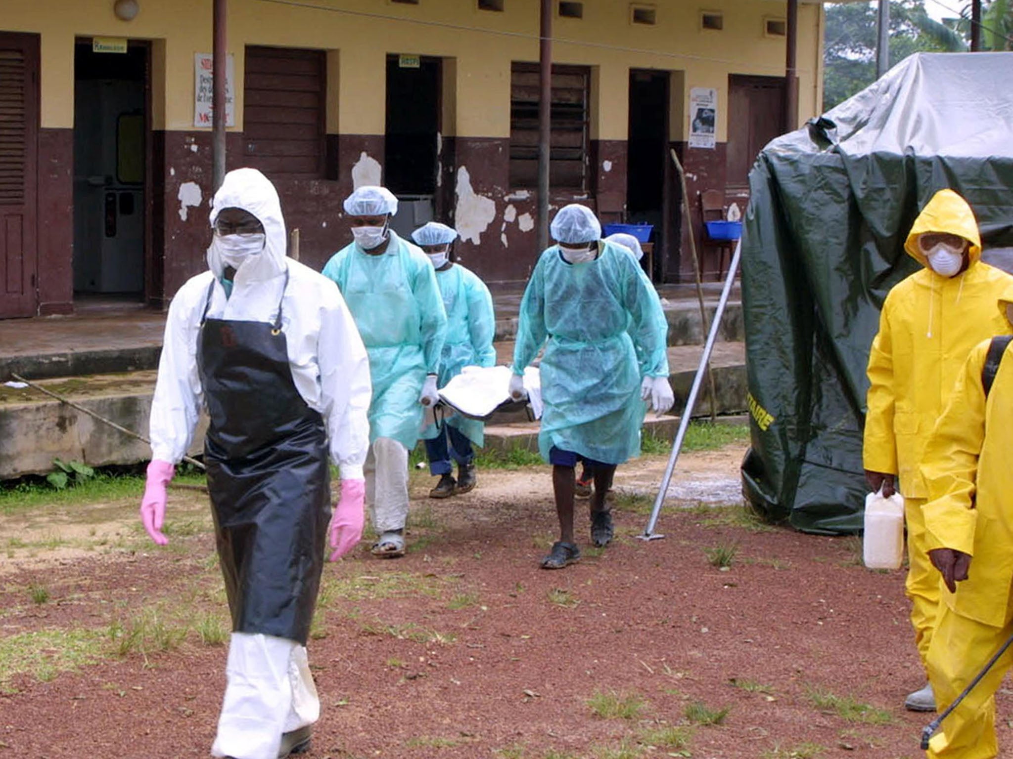 Relatives and medics carry the body of a teenager who died of Ebola at a hospital in Gabon in 2001