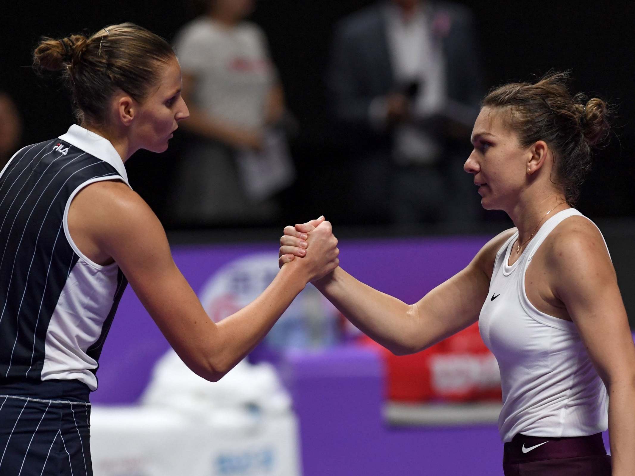 Halep and Pliskova embrace at the net