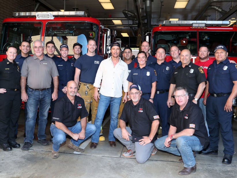 Matthew McConaughey poses with first responders during an Operation BBQ Relief event on 1 November