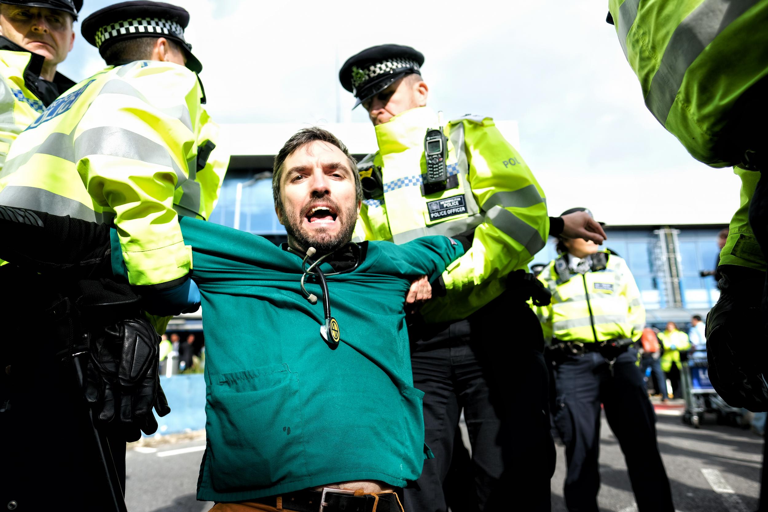 An Extinction Rebellion activist is arrested during a protest at London City Airport in October