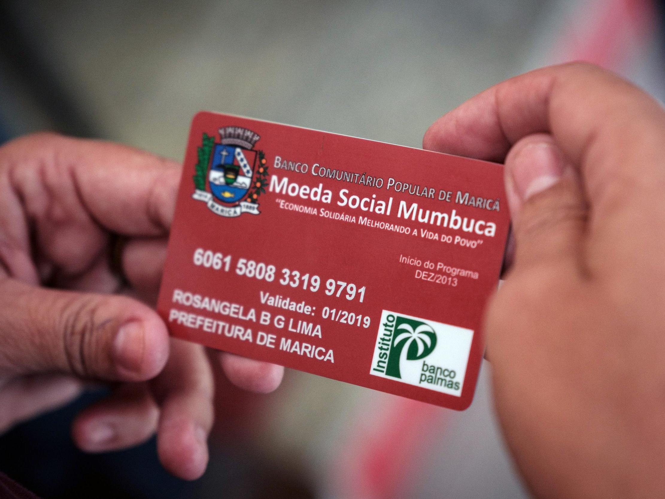 A woman uses her ‘Mumbuca’ card at pharmacy in Marica, Brazil