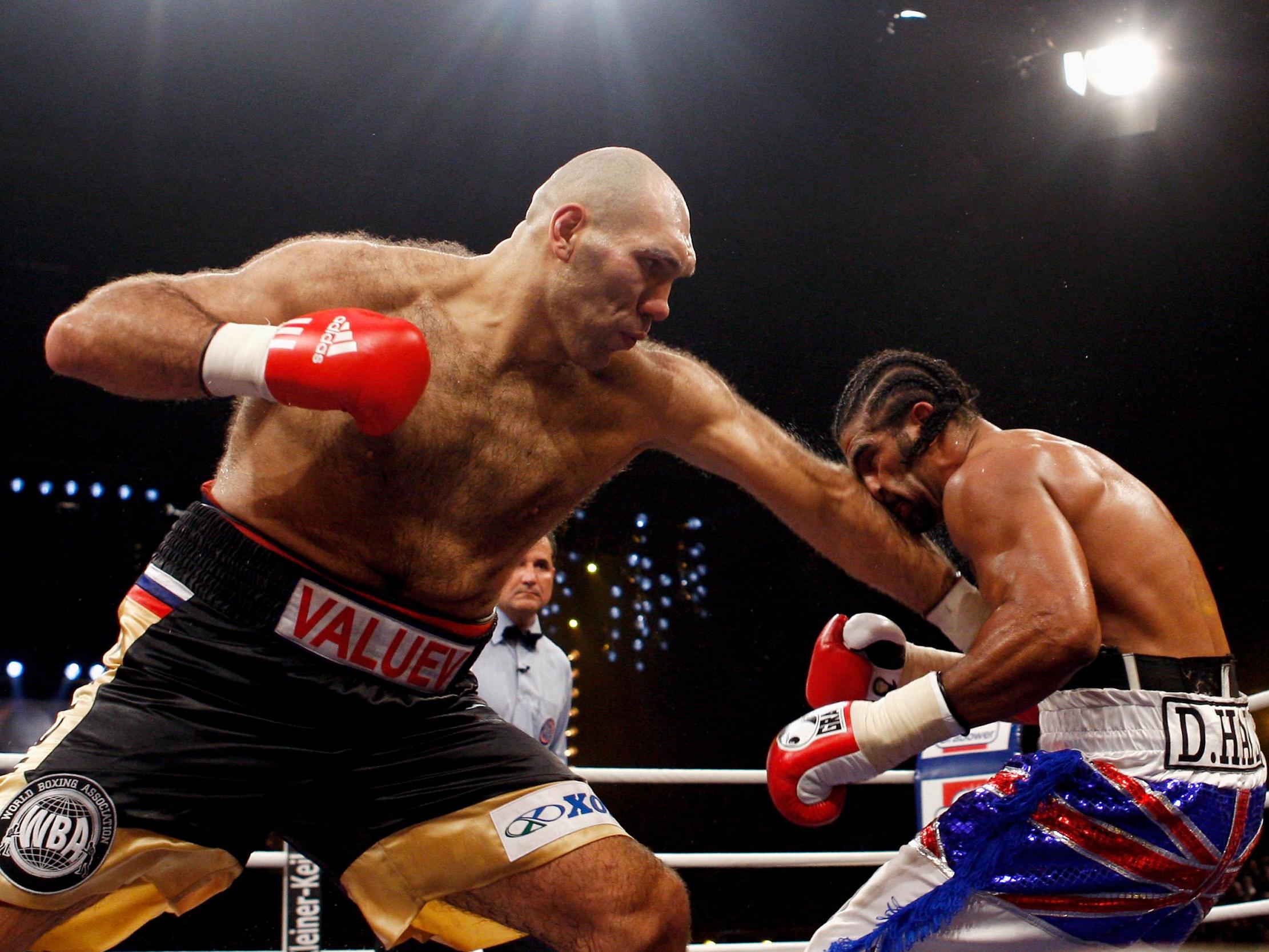 Nikolai Valuev lands a jab into the body of David Haye