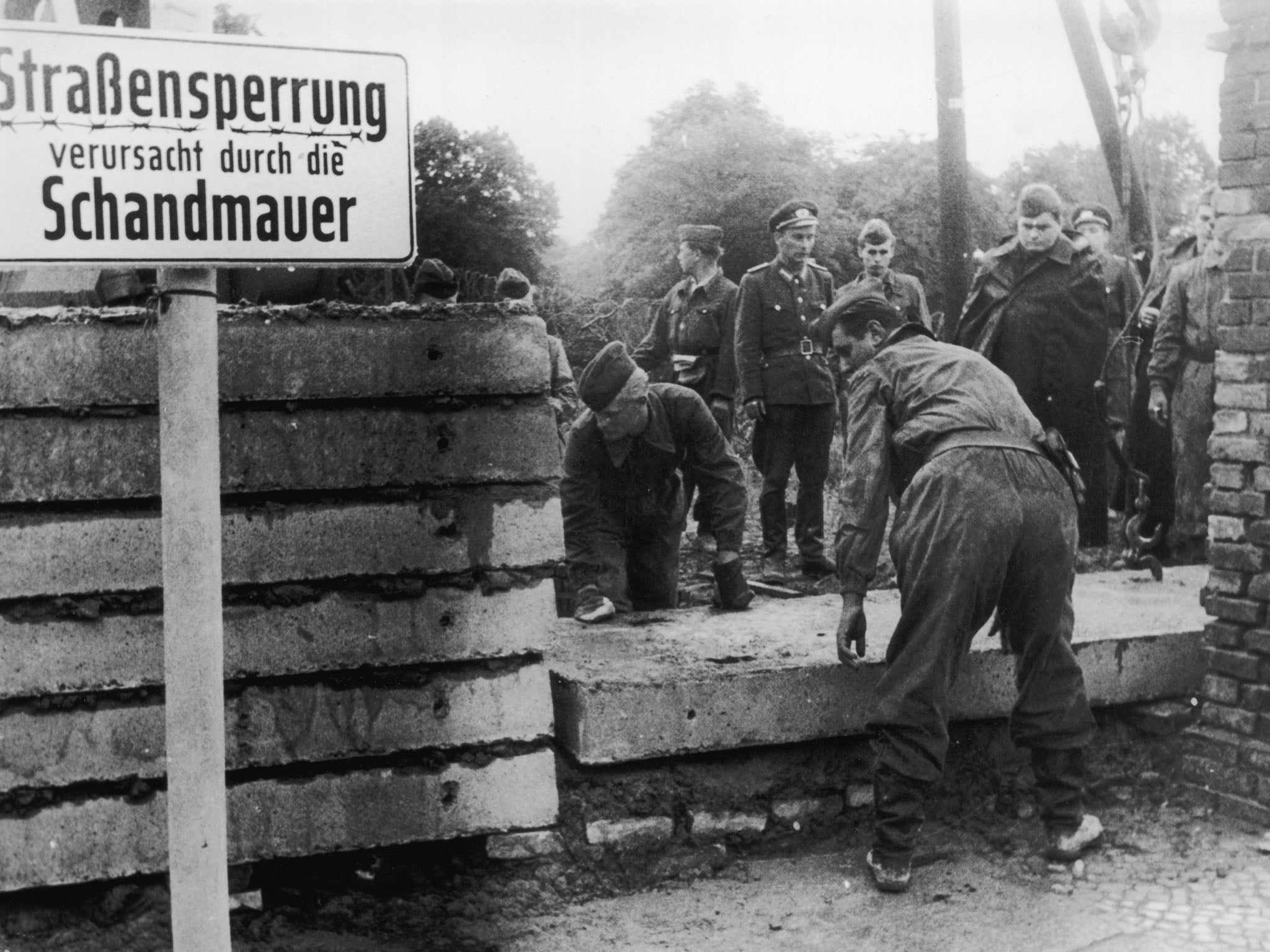 Soldiers building the Berlin Wall in 1961 as instructed by the East German authorities