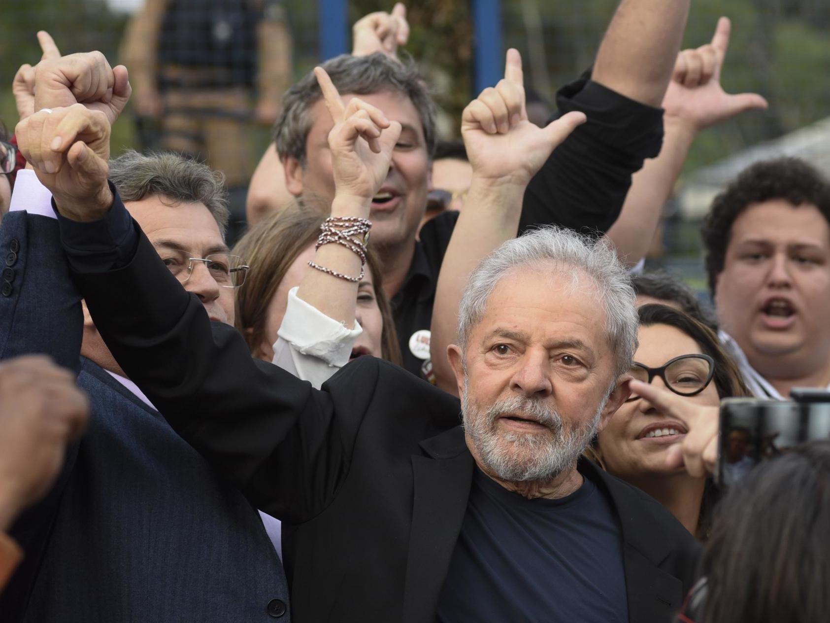 Former Brazilian president Lula gestures as he leaves prison, where he had been detained since April 2018