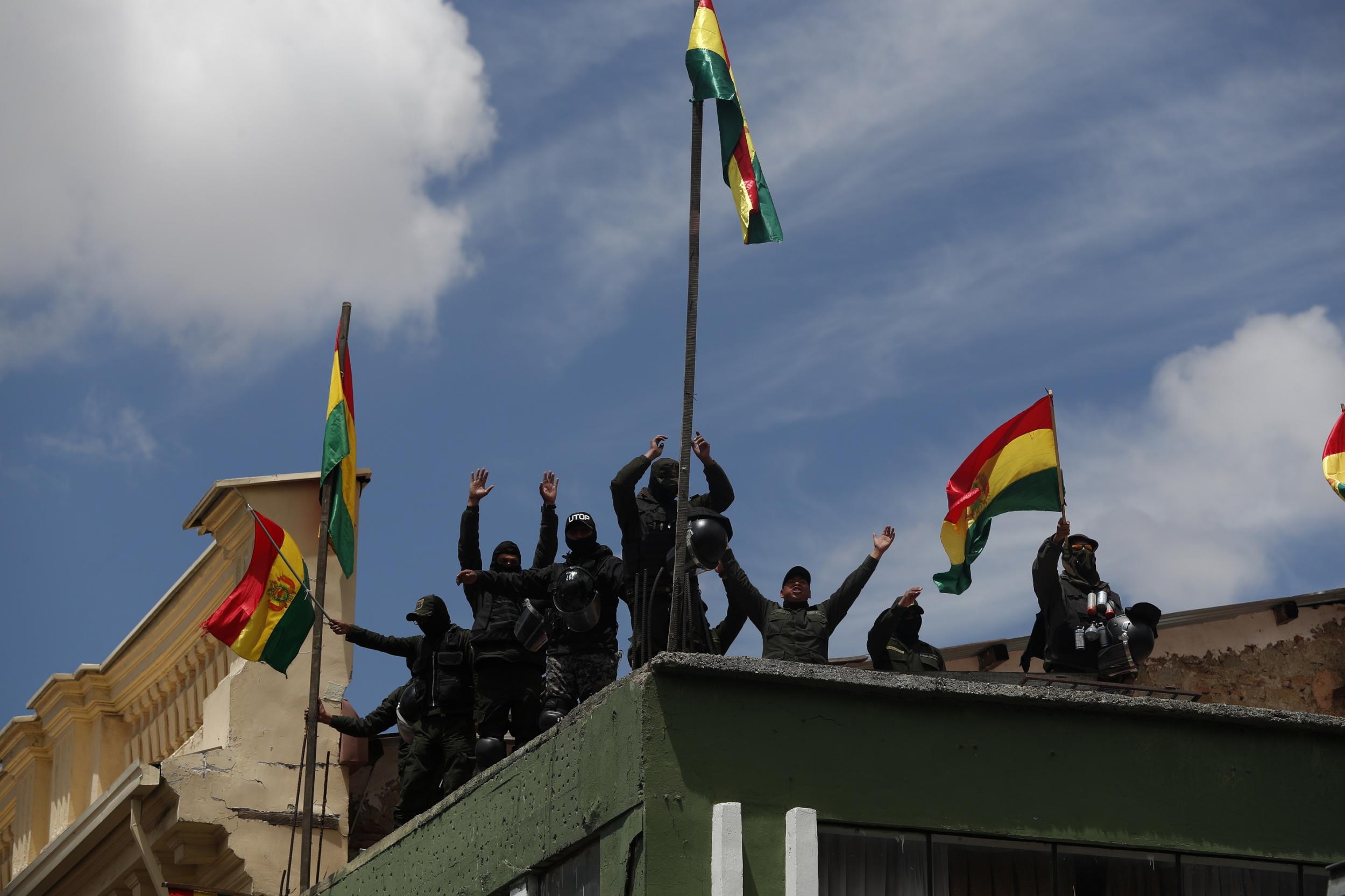 Police officers a stone's throw from the presidential palace in La Paz declare their backing for the anti-government protests wracking Bolivia