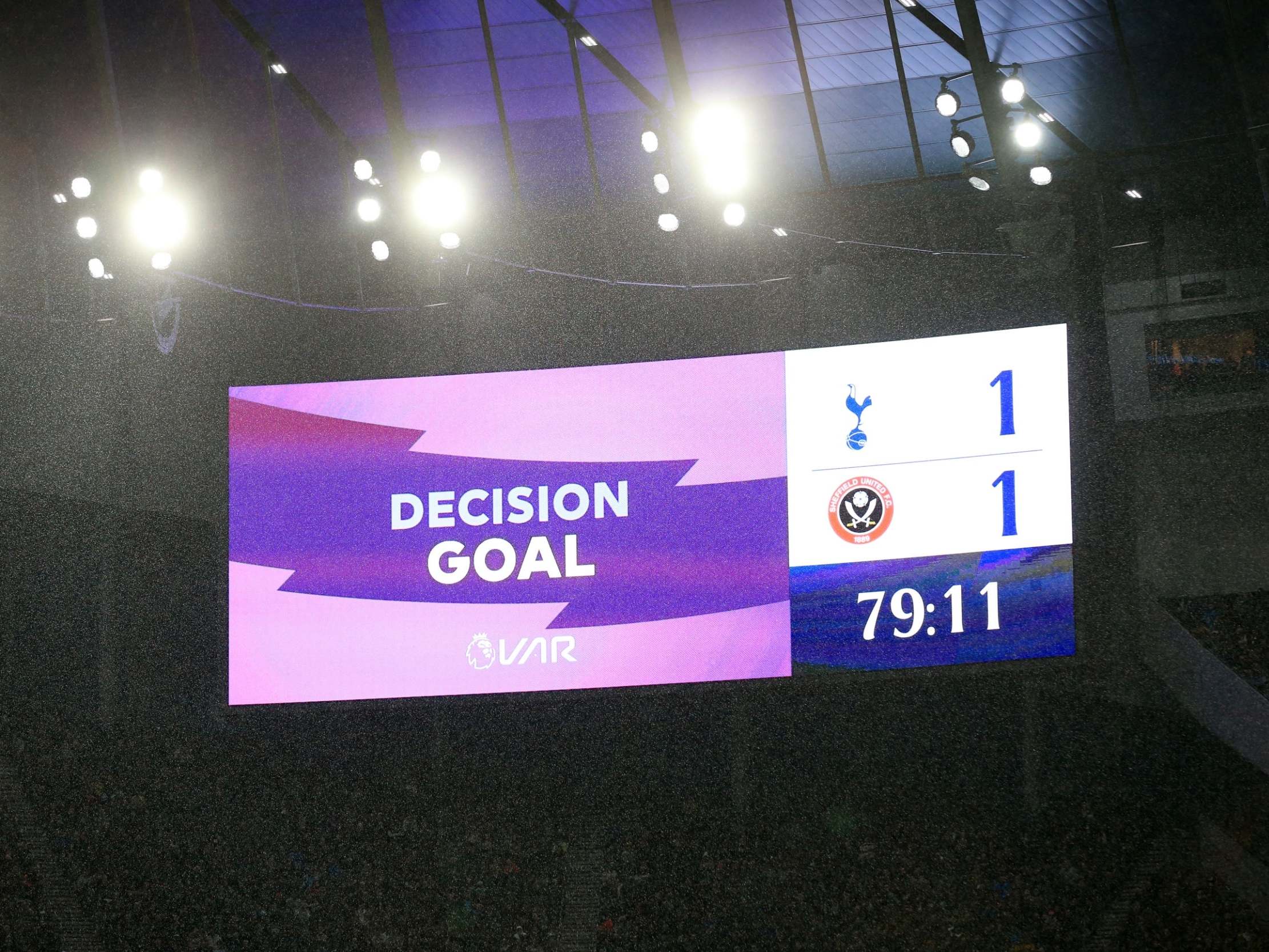 A screen inside the stadium displays a VAR check