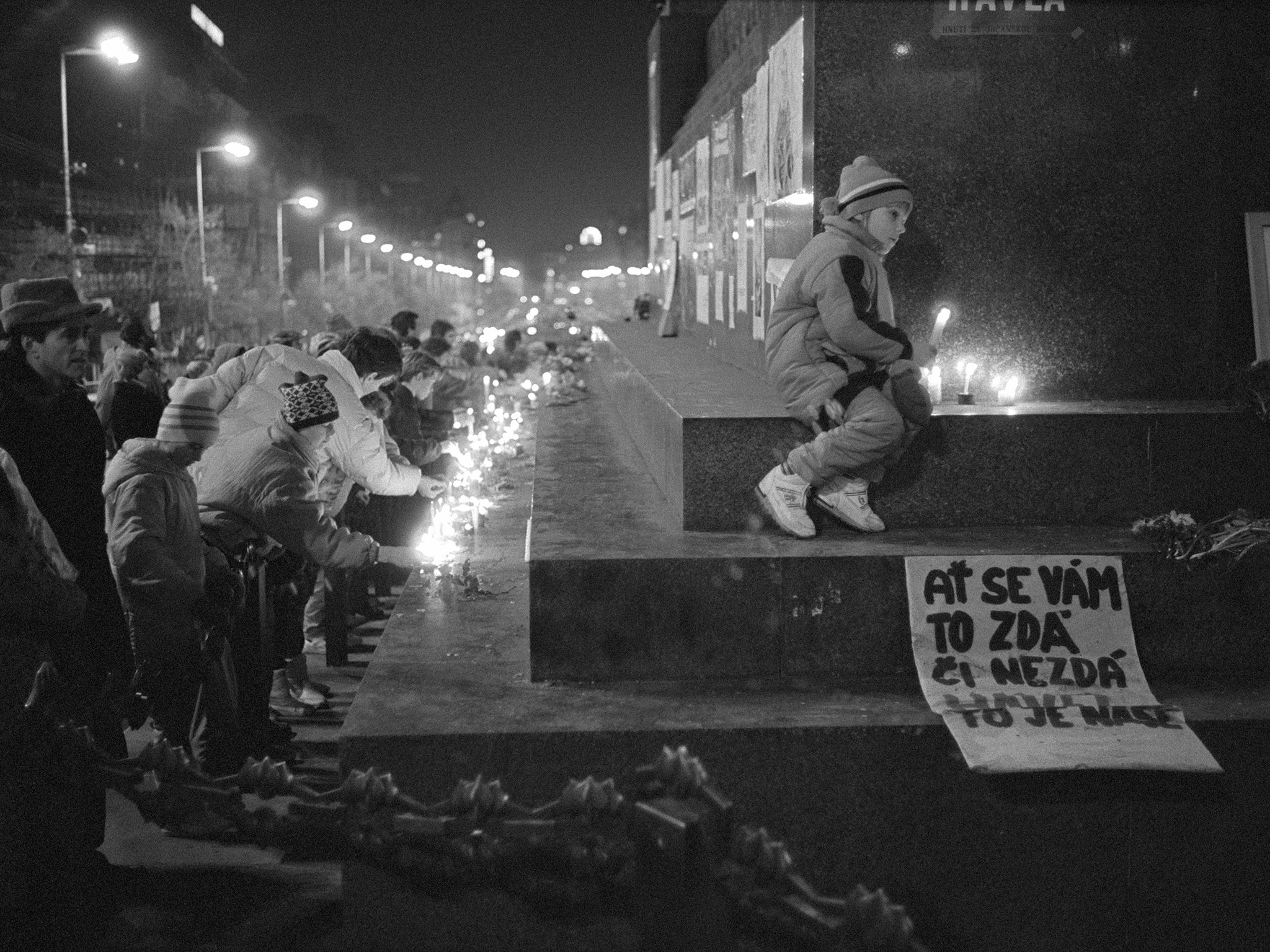 People attend a memorial to victims of the former regime in Czechoslovakia in 1989