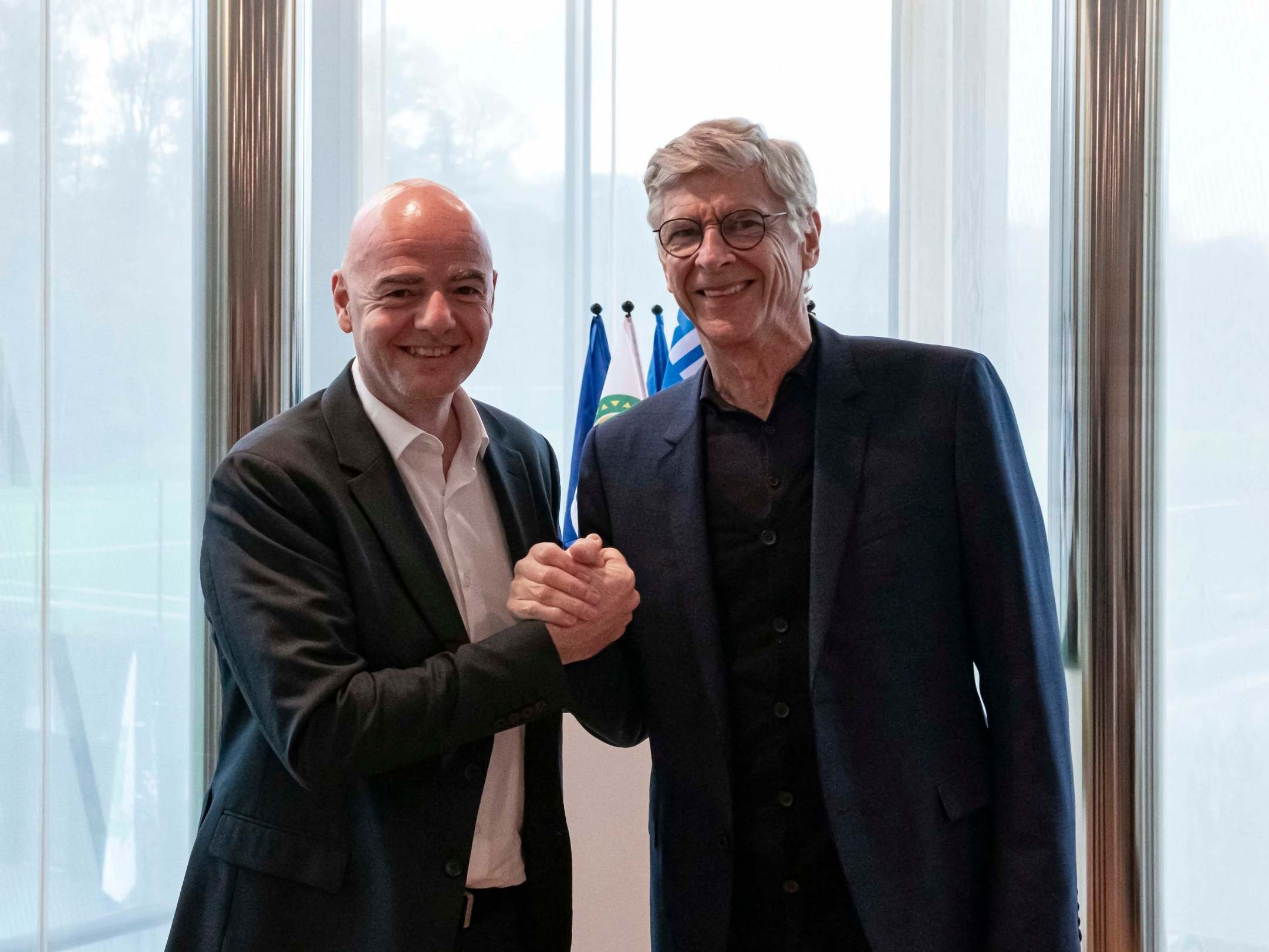 Gianni Infantino shakes hands with Arsene Wenger