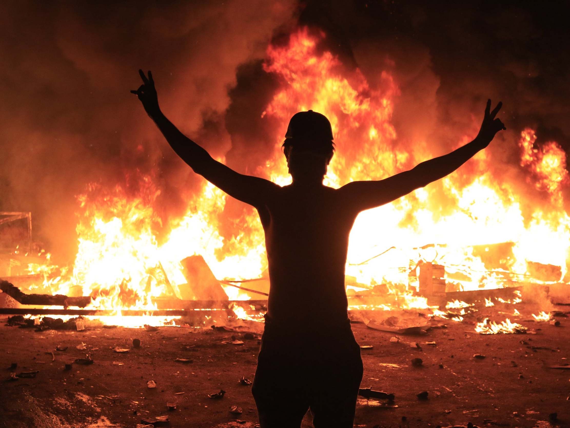 An Iraqi protester flashes the victory sign during a protest in Karbala, southern Iraq