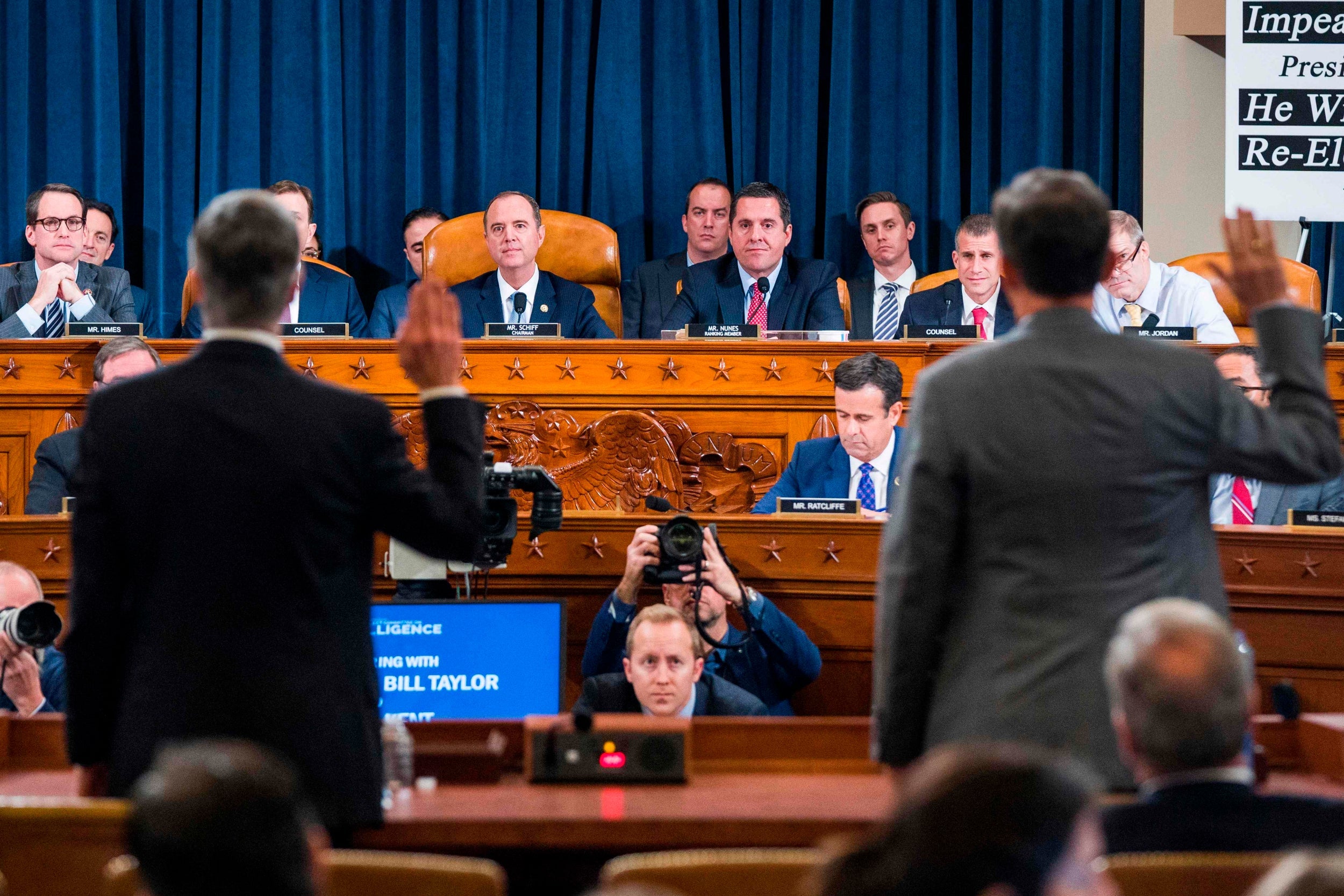 Officials are sworn in to the first public impeachment hearing on Wednesday morning