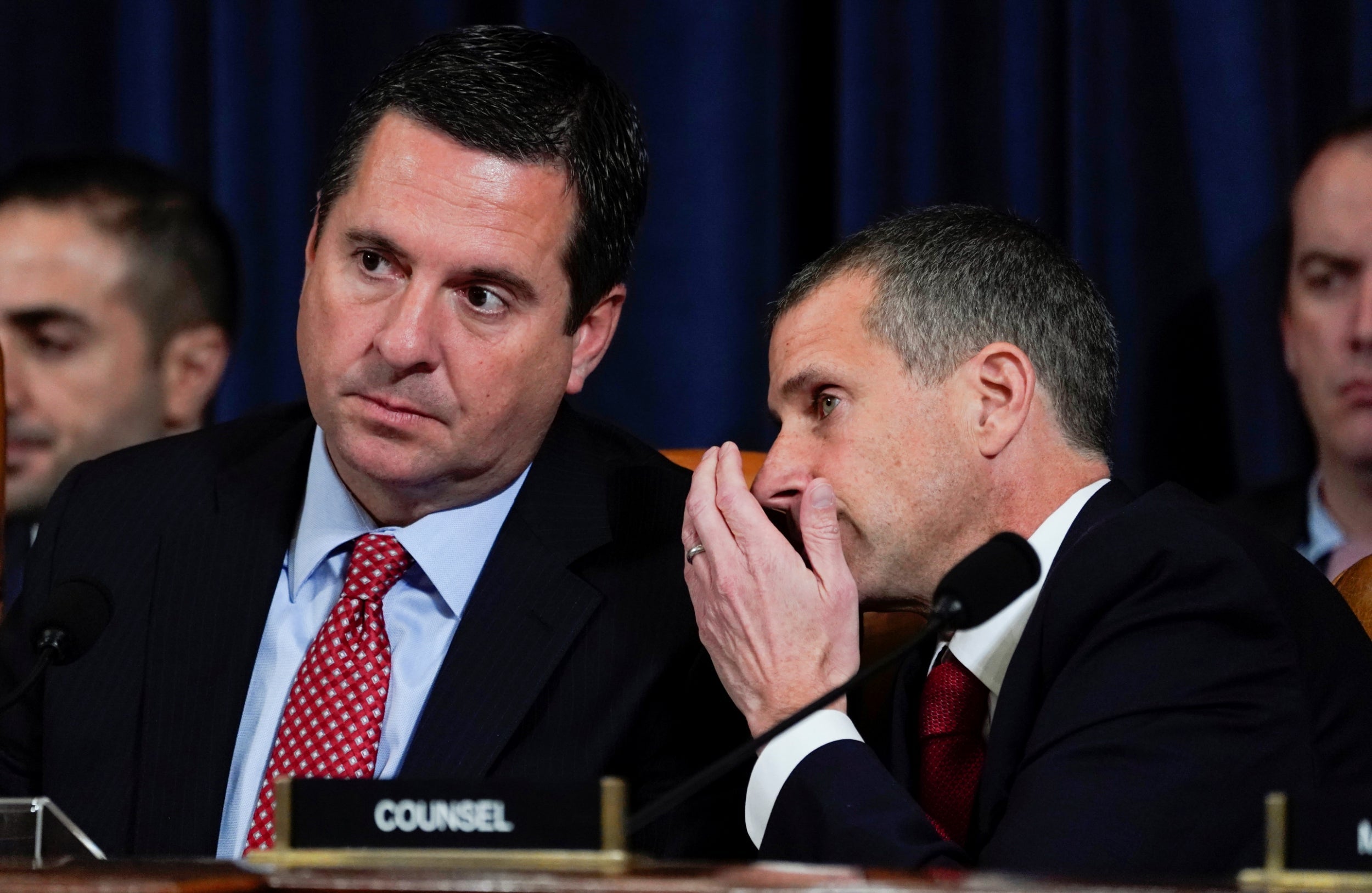 Republican counsel Steve Castor whispers to Devin Nunes during evidence by George Kent and William Taylor at the impeachment hearings into Donald Trump