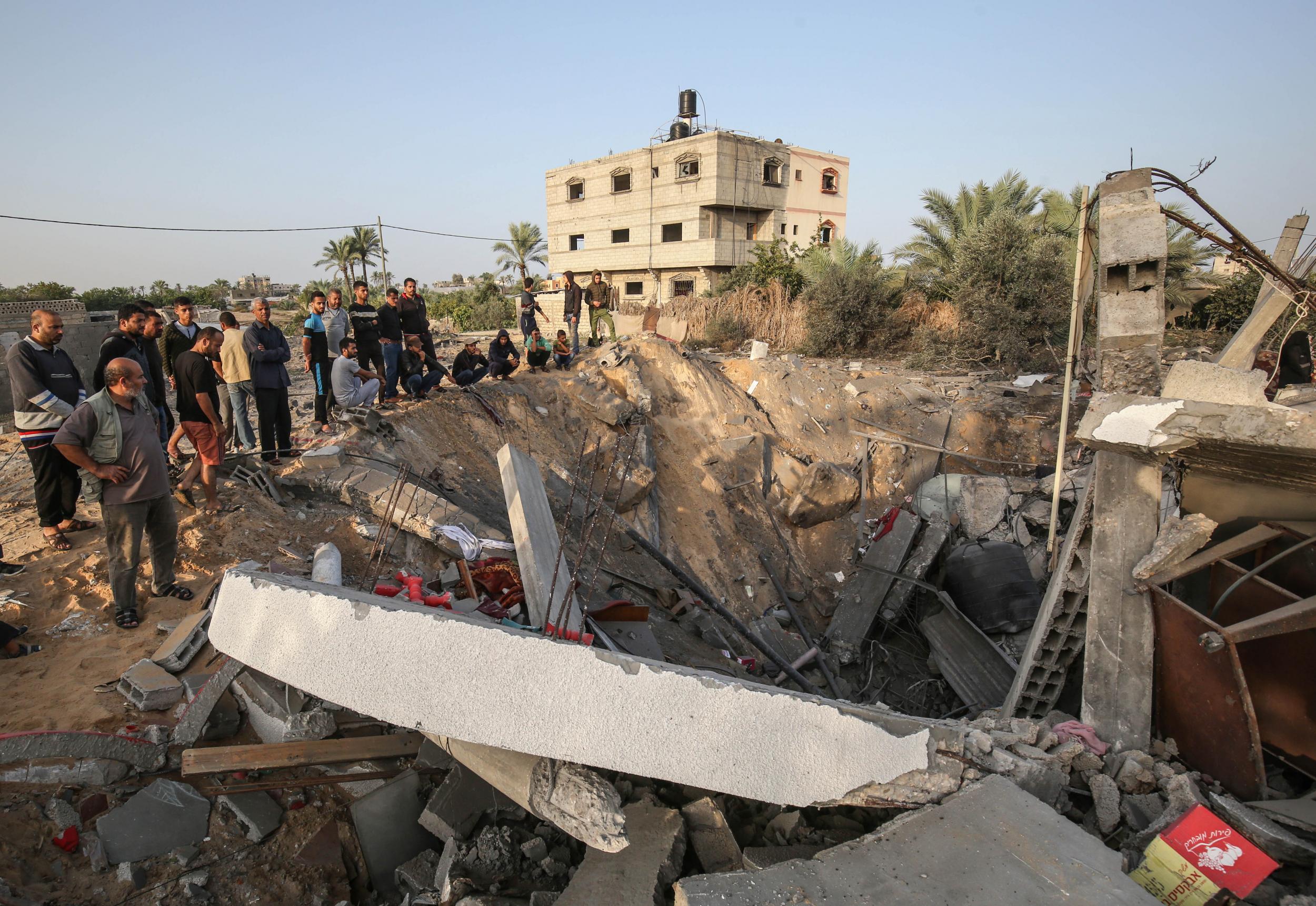 Palestinians check the remains of a house destroyed in an Israeli airstrike at Khan Yunis, in the southern Gaza Strip, on 13 November 2019