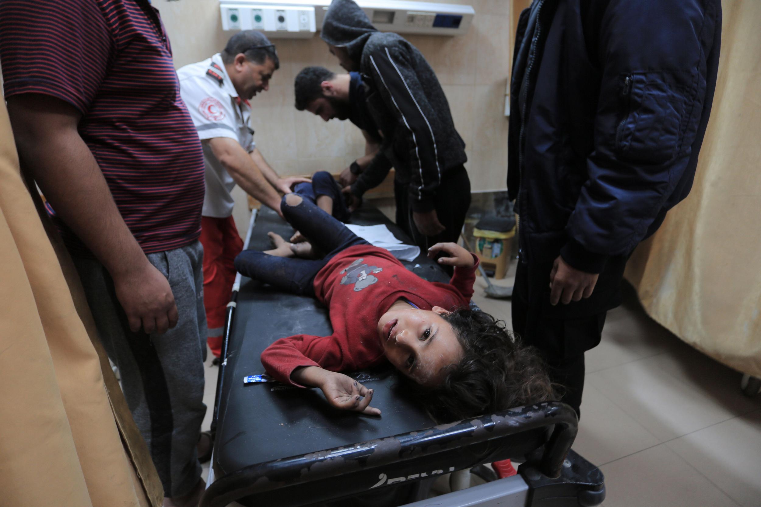 Palestinian medical workers tend to wounded children in central Gaza Strip’s Deir al-Balah on 14 November 2019 (AFP)