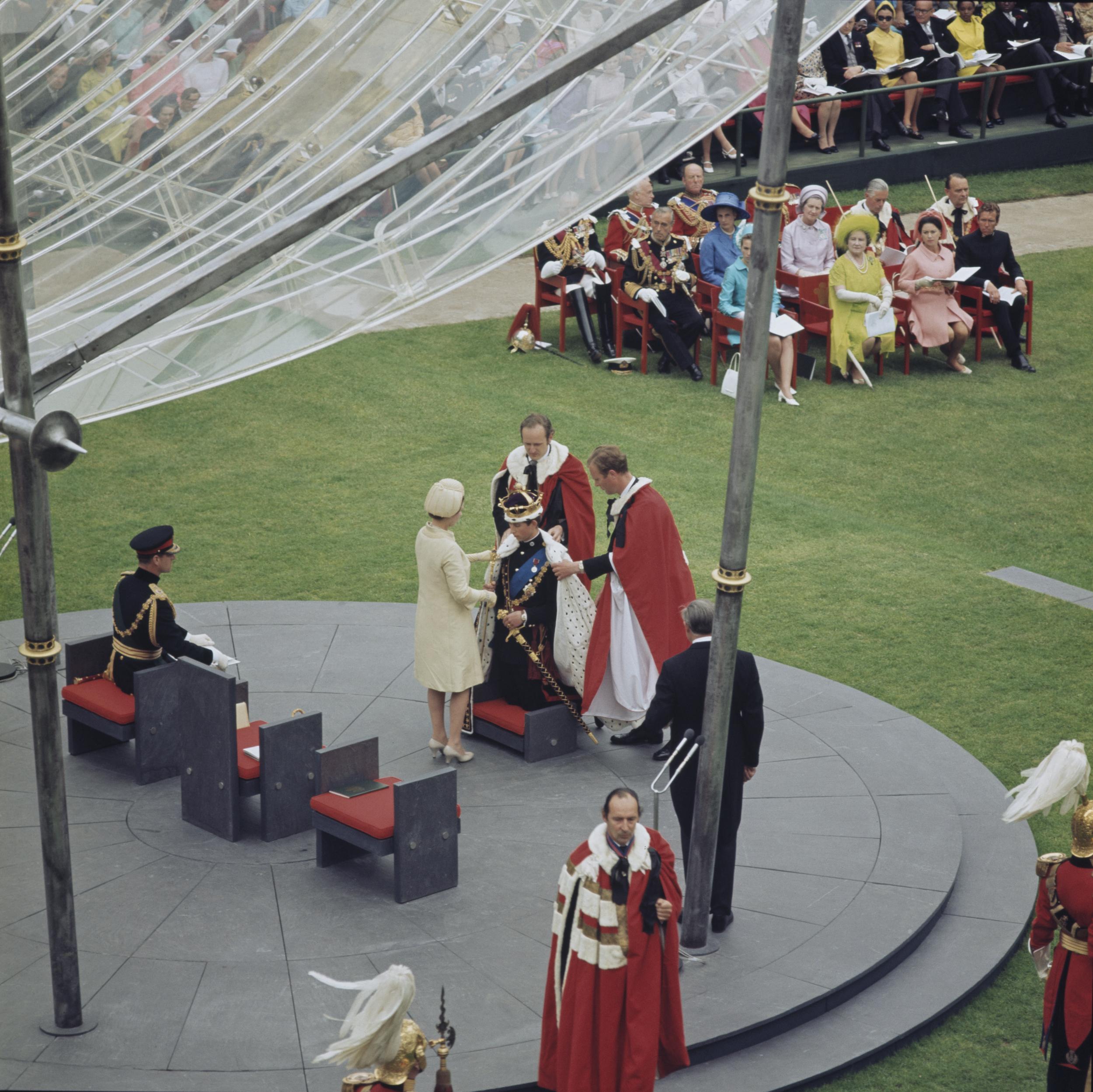 Prince Charles kneels before the Queen during the ceremony of his investiture as Prince of Wales at Caernarfon Castle, Gwynedd, Wales, 1 July 1969