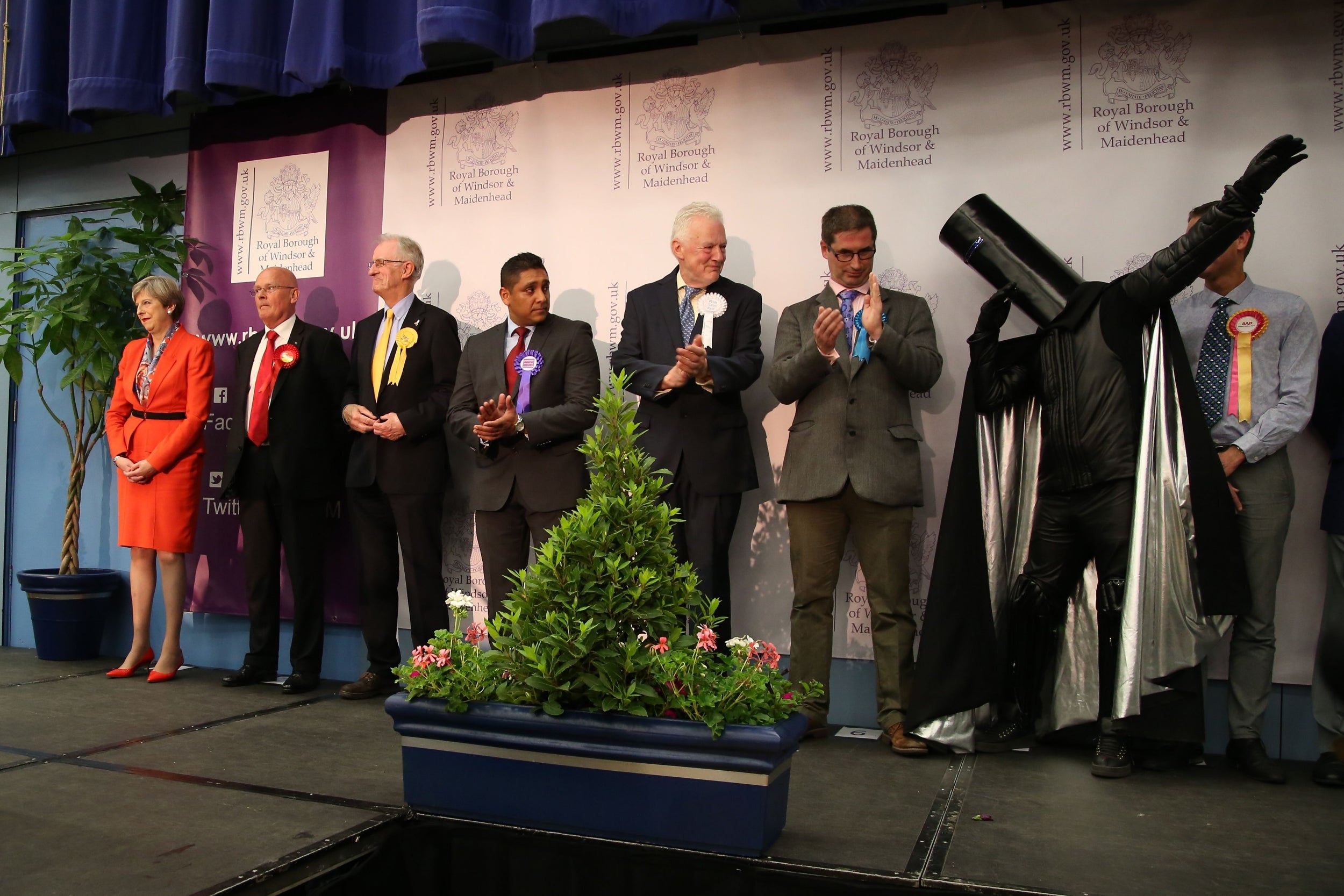 Lord Buckethead strikes a pose while sharing the stage with former prime minister Theresa May during the 2017 general election