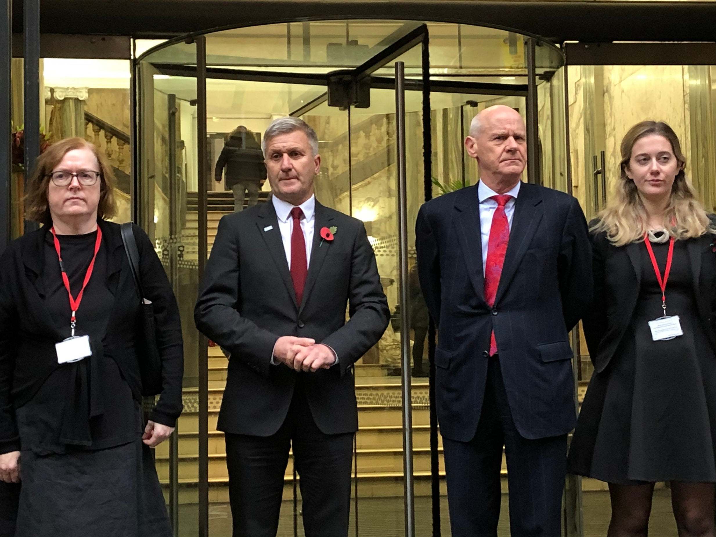 Dr Richard Freeman, second left, outside the tribunal in Manchester