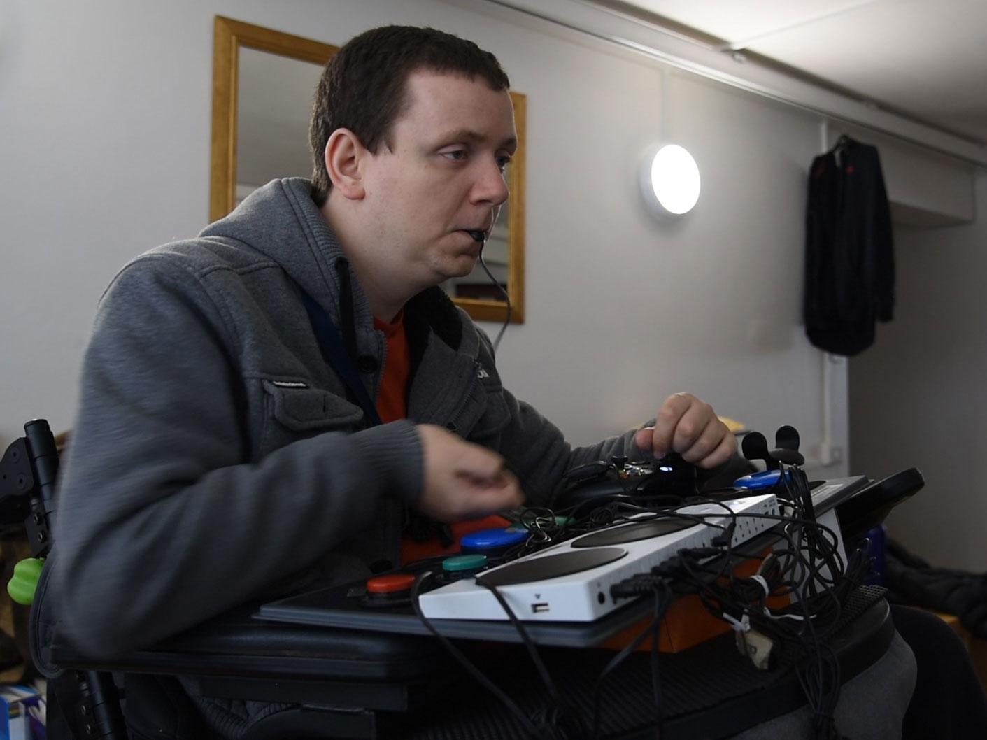 Paul Phillips, 27, in his home in St Albans: ‘I like being competitive online, and showing that people with disabilities can play just as well’