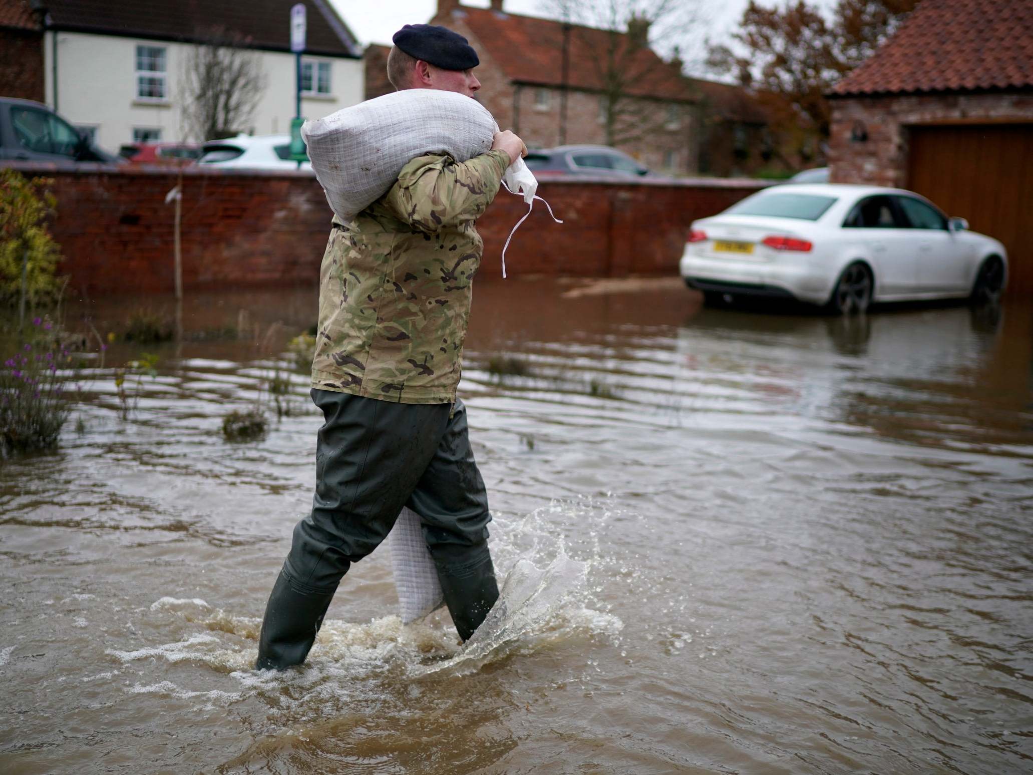 Soldiers help with sandbagging homes in the village of Fishlake