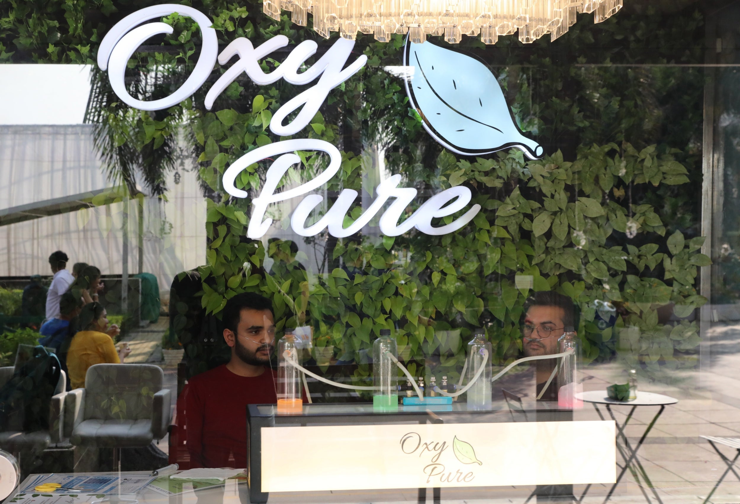 Customers sitting inside the bar with oxygen tanks filled with scented air