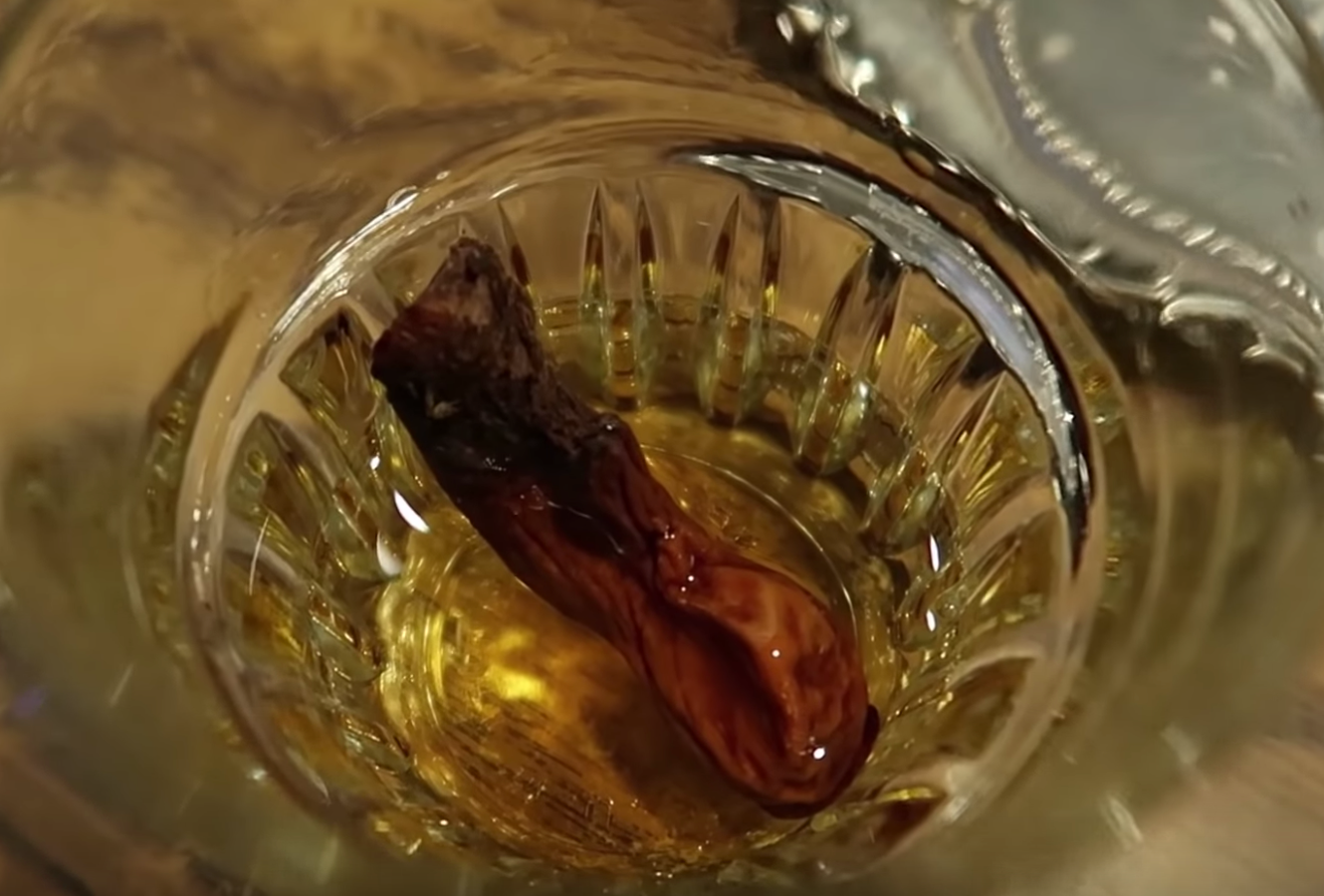 A mummified amputated toe bobs in a shot of whisky