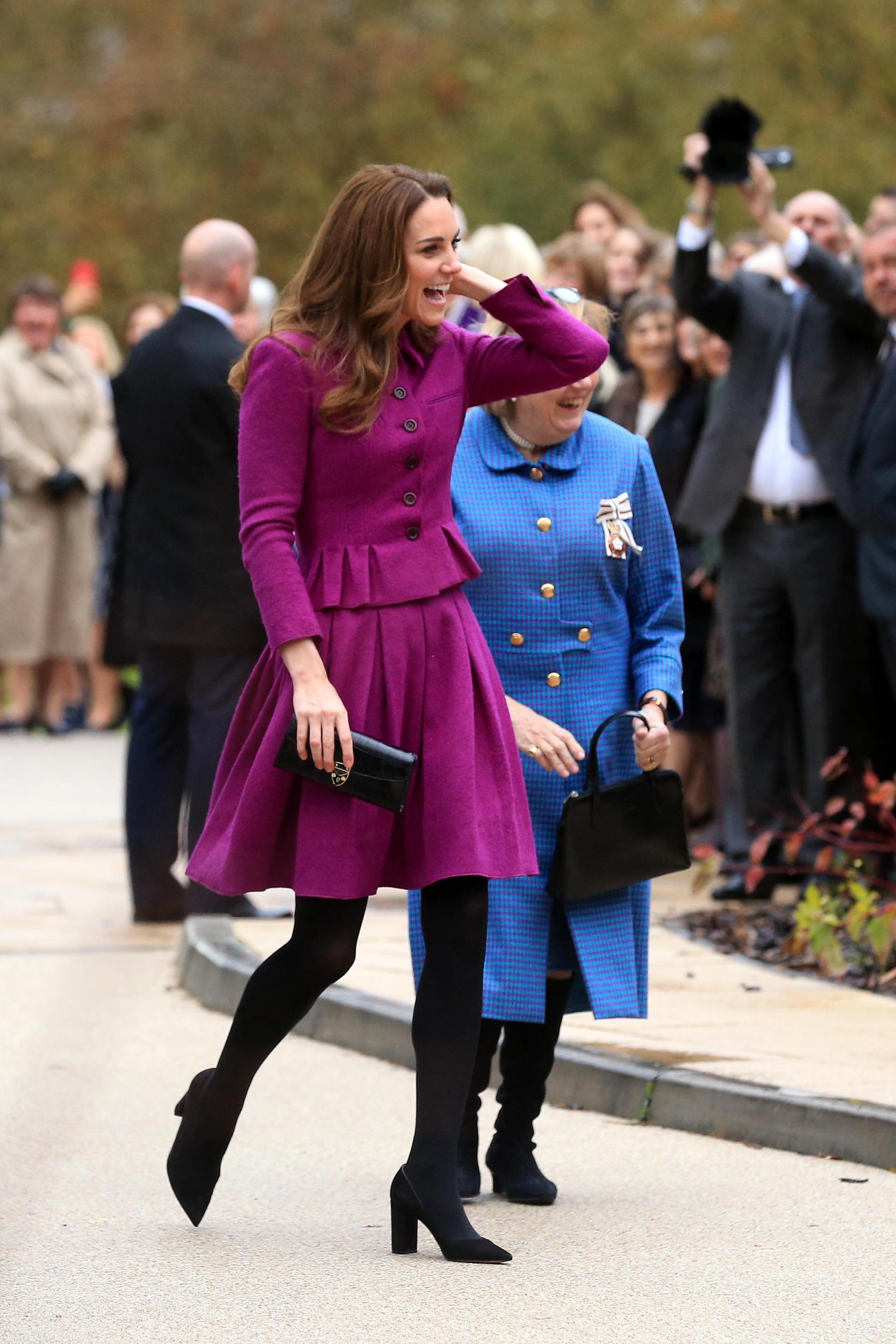 The duchess paired the black tights with a magenta skirt suit (Getty)