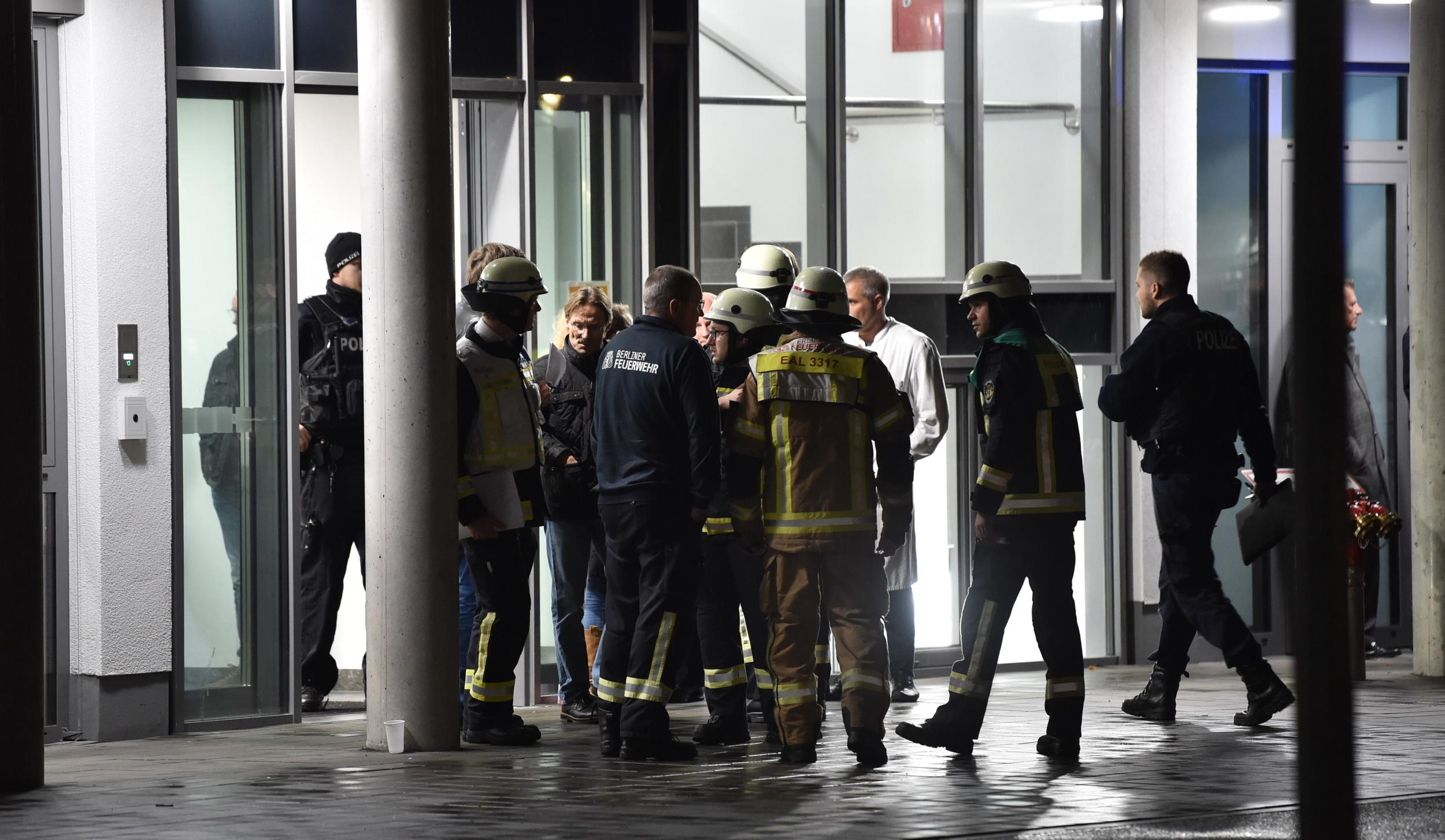 Policemen, firefighters and medical staff stand in front of the Schlosspark hospital after the attack (dpa/AFP/Getty)