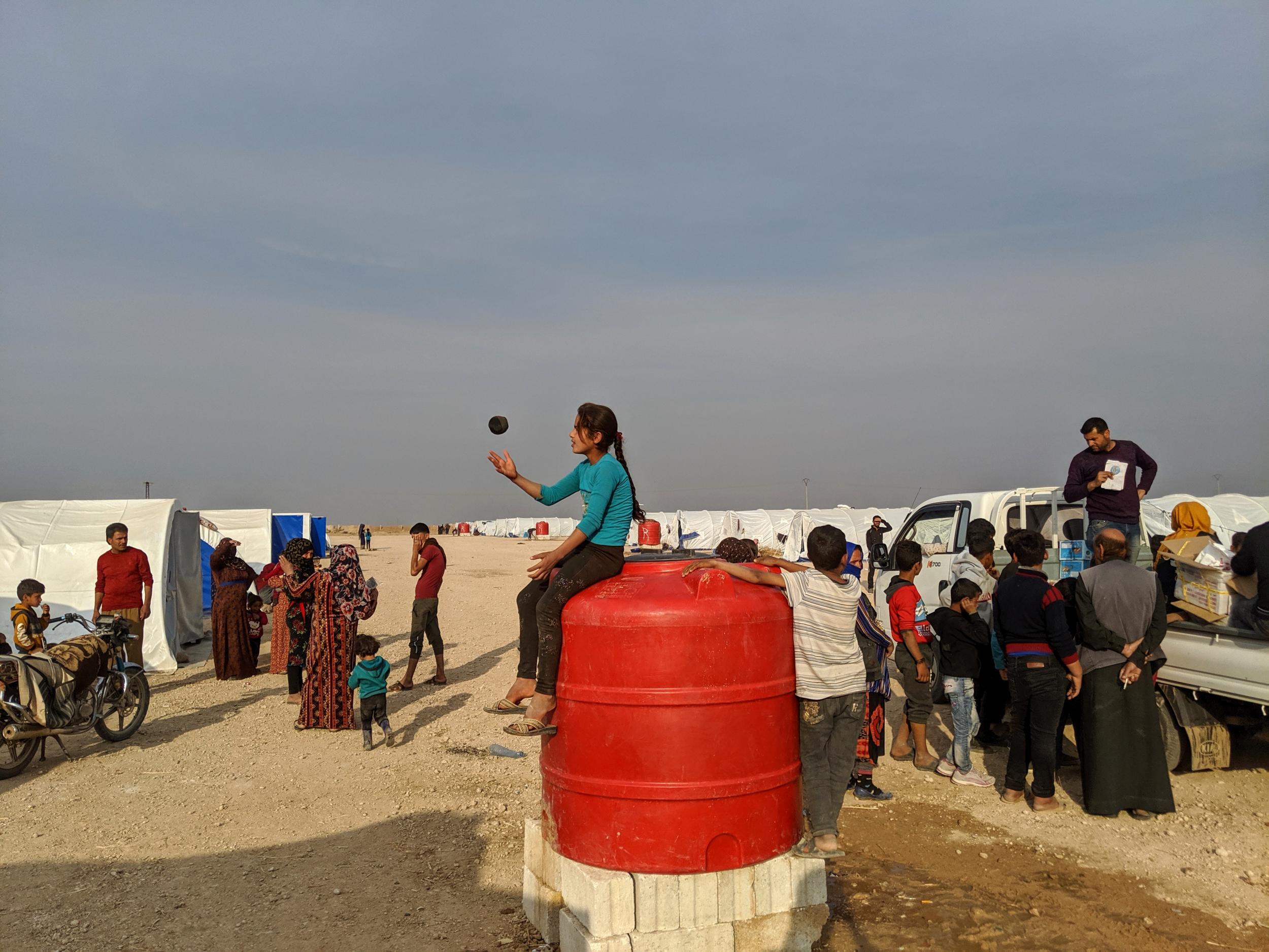 A girl plays with a ball at a newly-opened displacement camp just outside Tal Tamr (Richard Hall/The Independent)