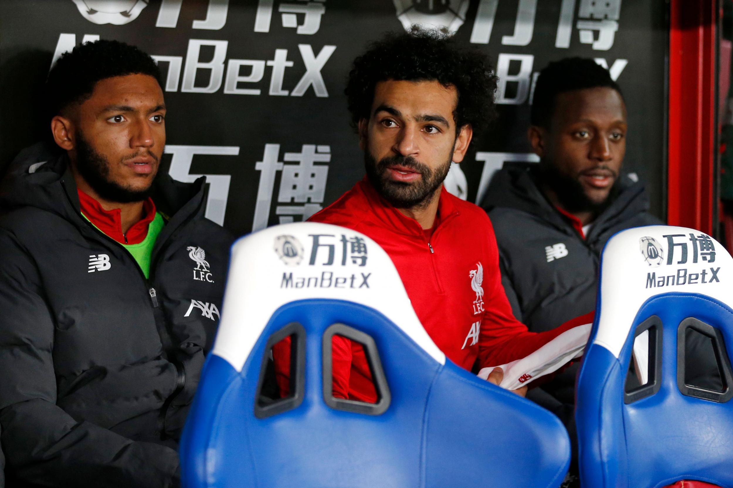 Mohamed Salah sits on the bench for Liverpool