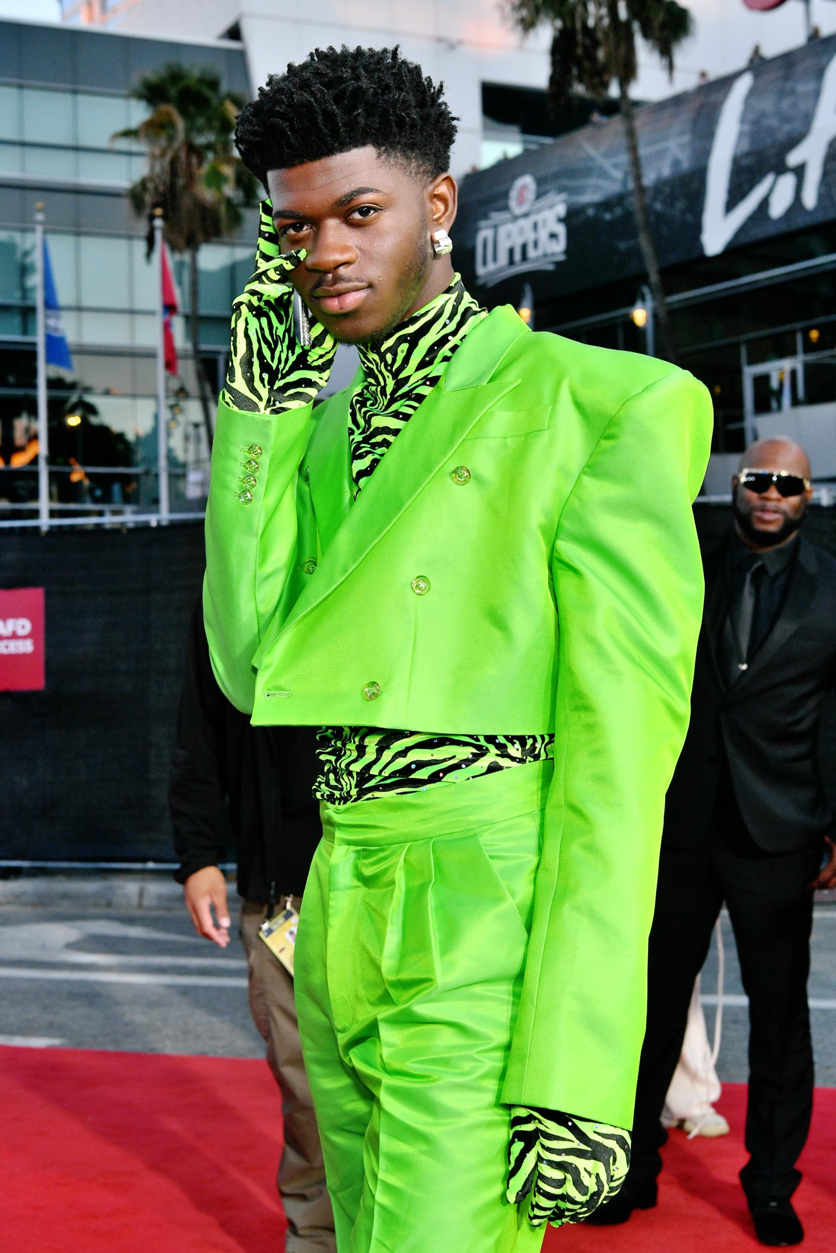 The American rapper turned heads in this eye-popping neon green look, comprising a double-breasted suit, zebra print poloneck top and matching gloves.
