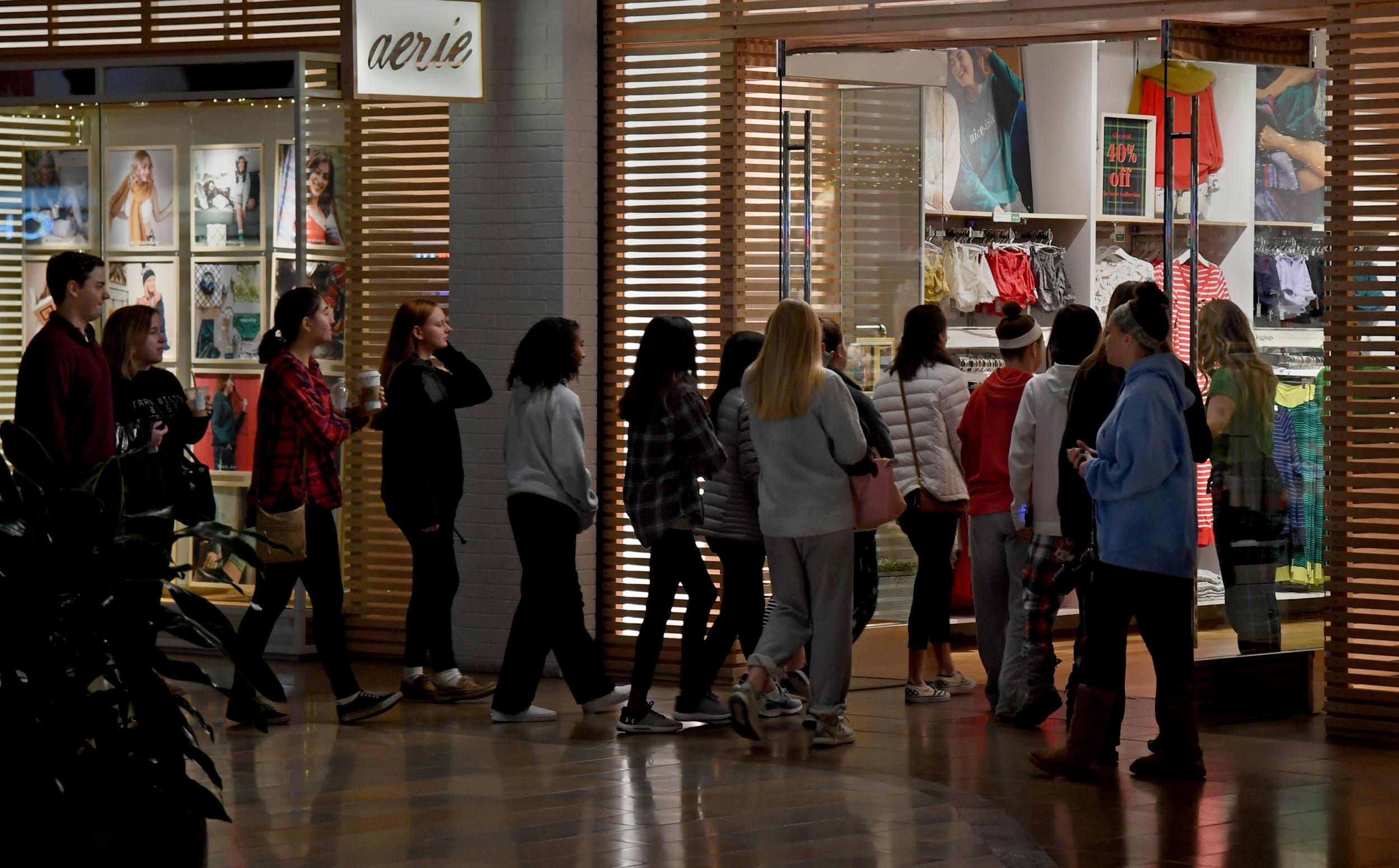 Shoppers line up at the door of the aerie store in Columbia Mall in the Washington suburb of Columbia, Maryland, just as it opened at 6am on Black Friday 2018