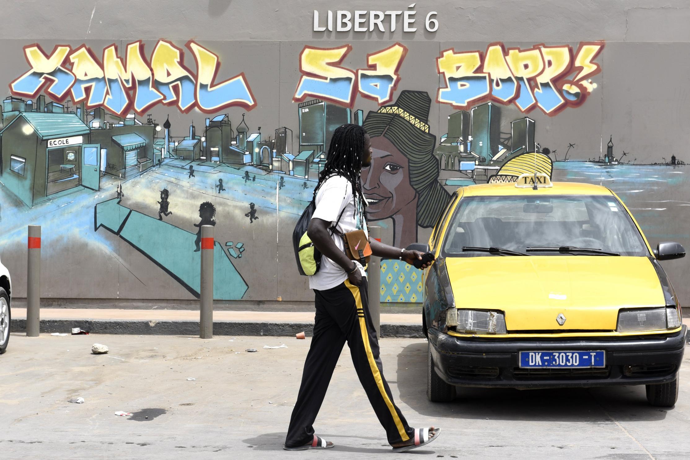 A wall depicts an Ebola prevention message (AFP/Getty)