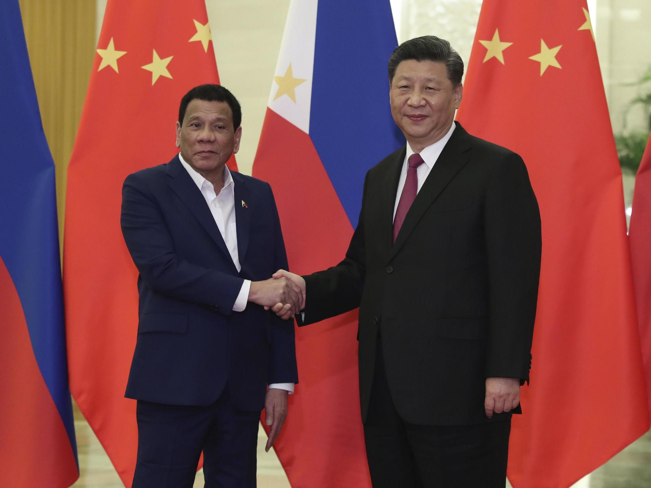 Philippine president Rodrigo Duterte, left, shakes hands with Chinese president Xi Jinping, during a meeting in April