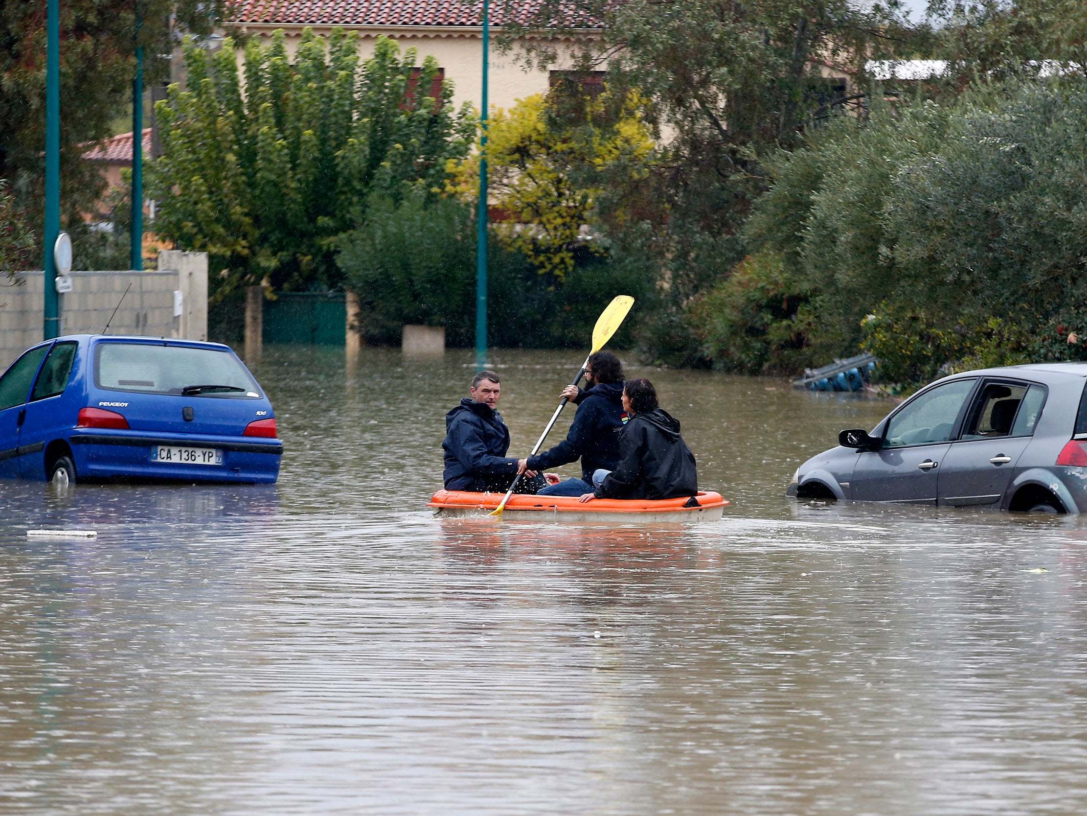 People use a canoe to navigate submerged streets after heavy rainfall hit the Var department overnight in Le Muy, France