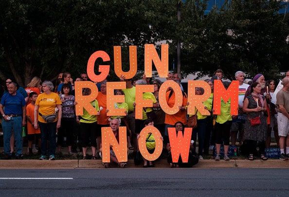 Gun control advocates take part in a candlelit vigil outside the NRA headquarters in Fairfax, Virginia