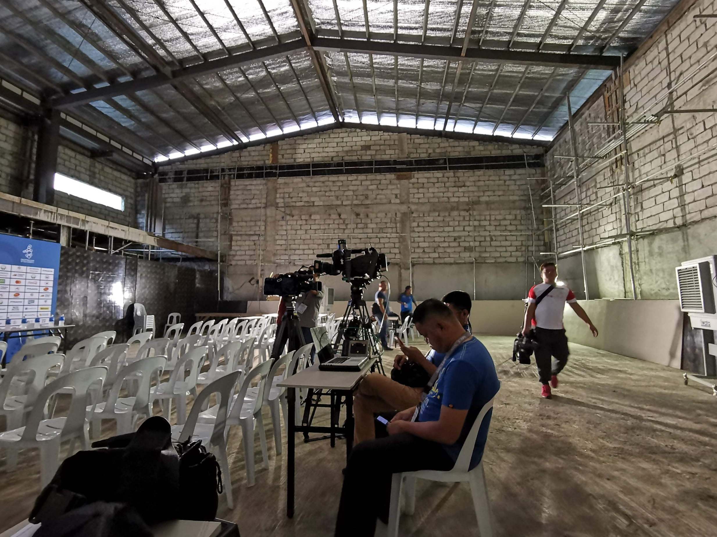 Journalists wait for a press conference at a temporary media centre in Manila