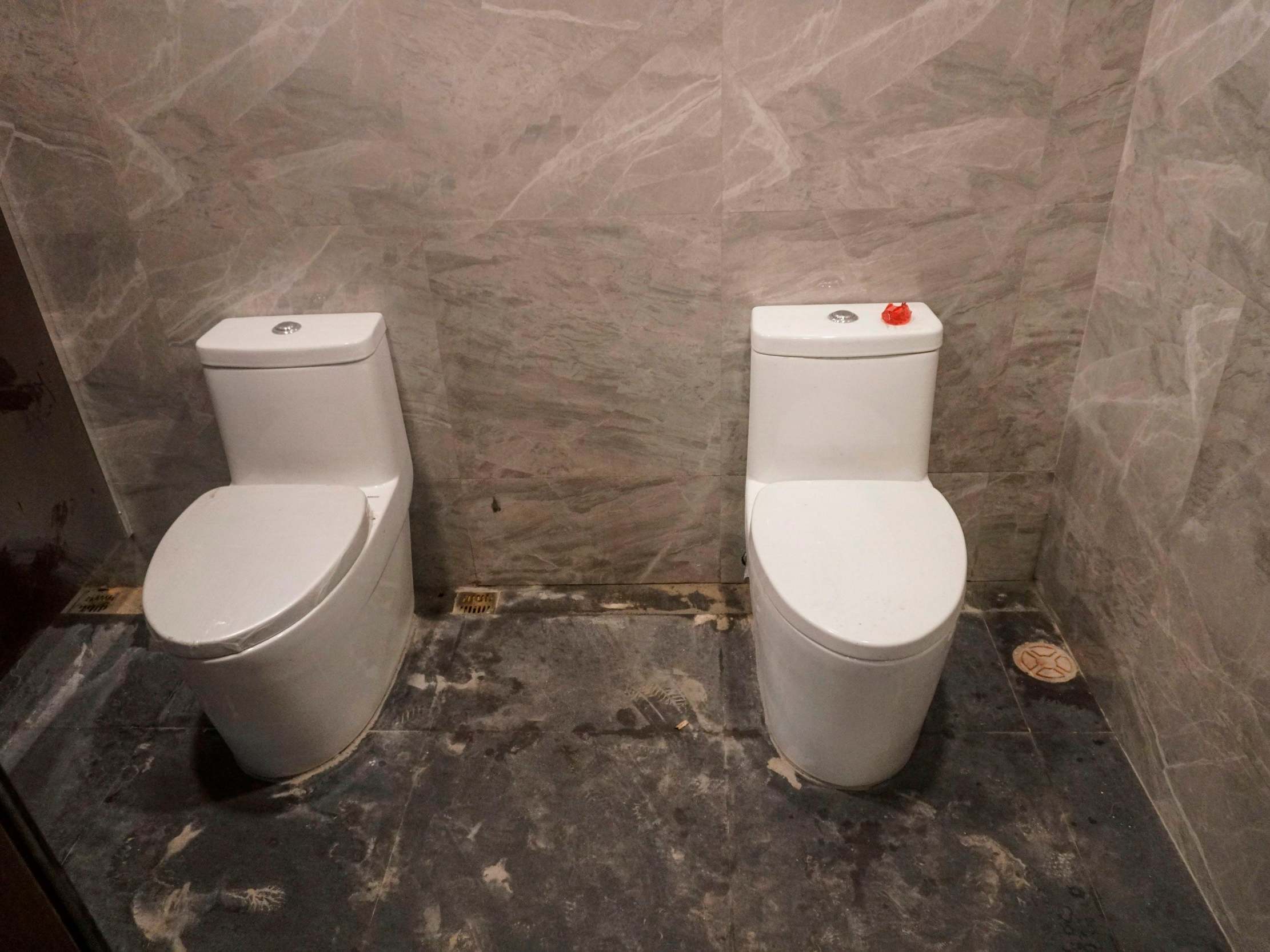 Two toilets in one cubicle at the Rizal memorial collisium in Manila