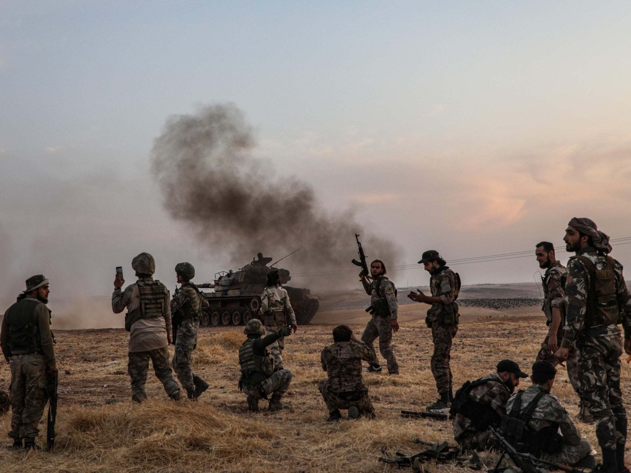 Turkish soldiers and Turkey-backed Syrian fighters gather on the northern outskirts of the Syrian city of Manbij in October