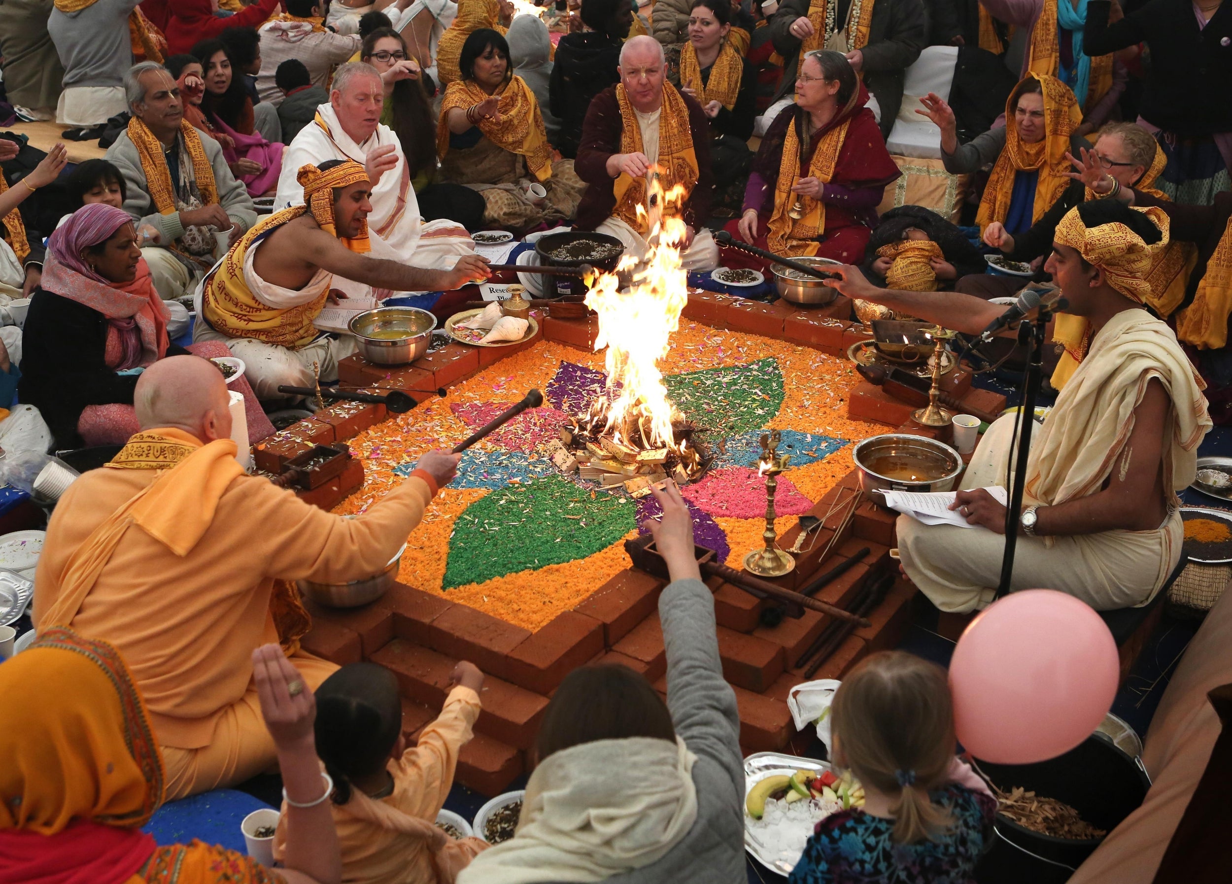 Members of the Hare Krishna congregation take part in a holy hindu ritual called Yajna at the Bhaktivedanta Manor Krishna temple in Hertfordshire (PA)