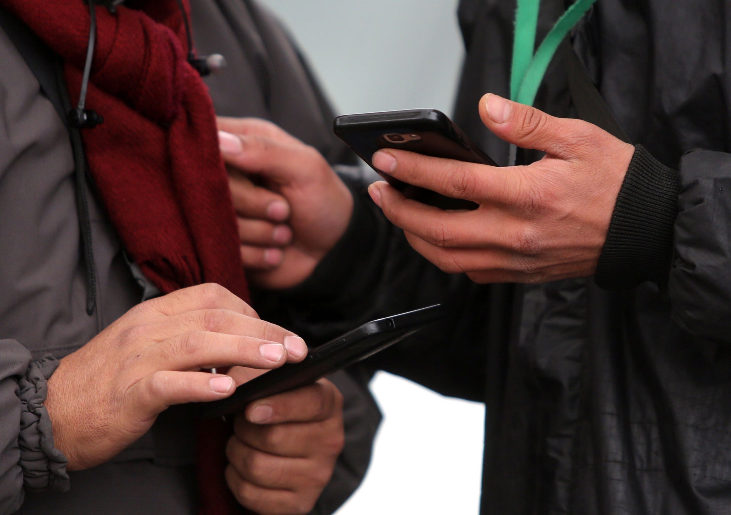 Iranians, pictured on their phones in Tehran, are struggling to adjust to life offline