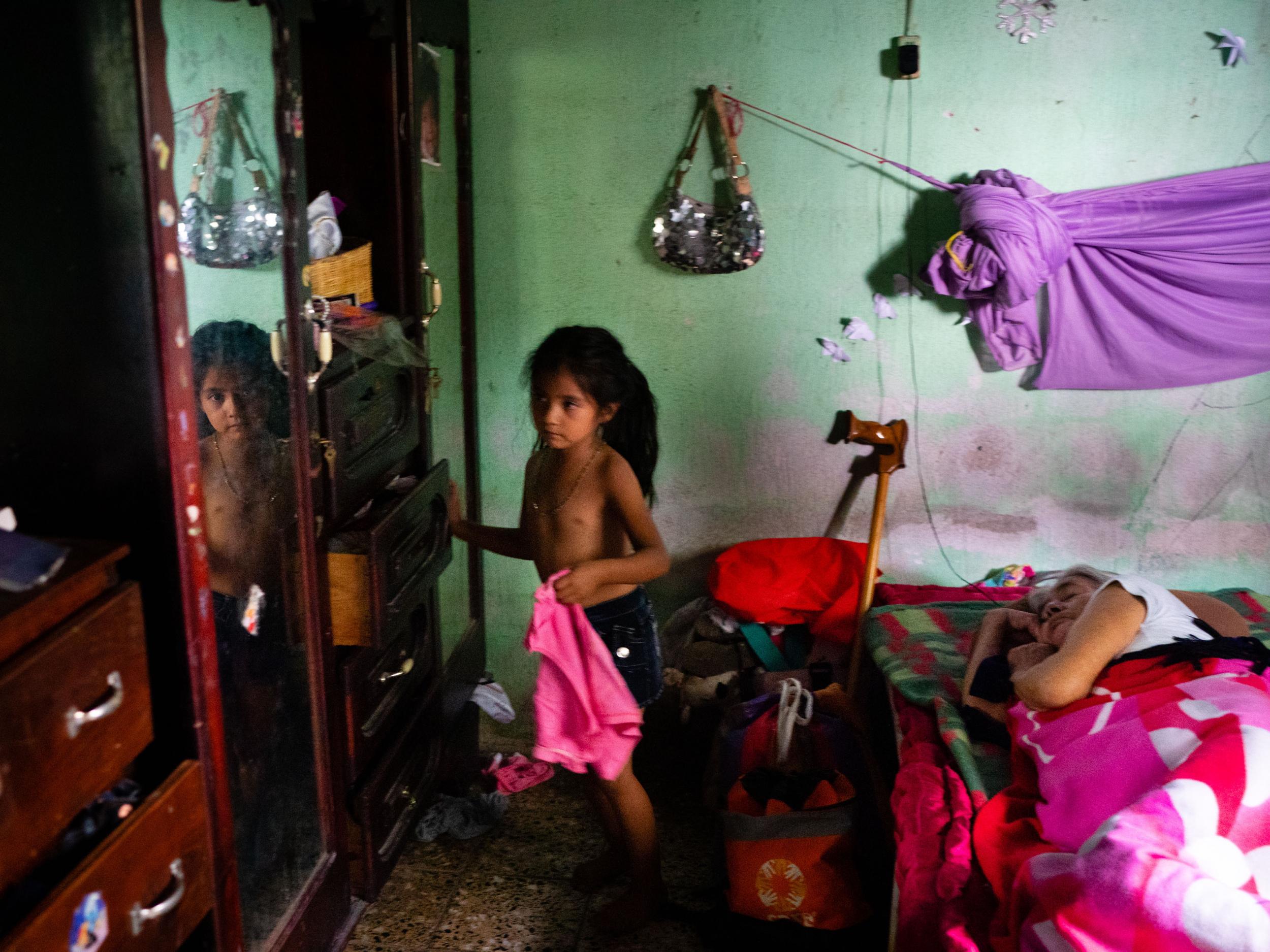 Marjorie Camposeco Lopez and grandmother in a bedroom shared with the whole family (The Washington Post)