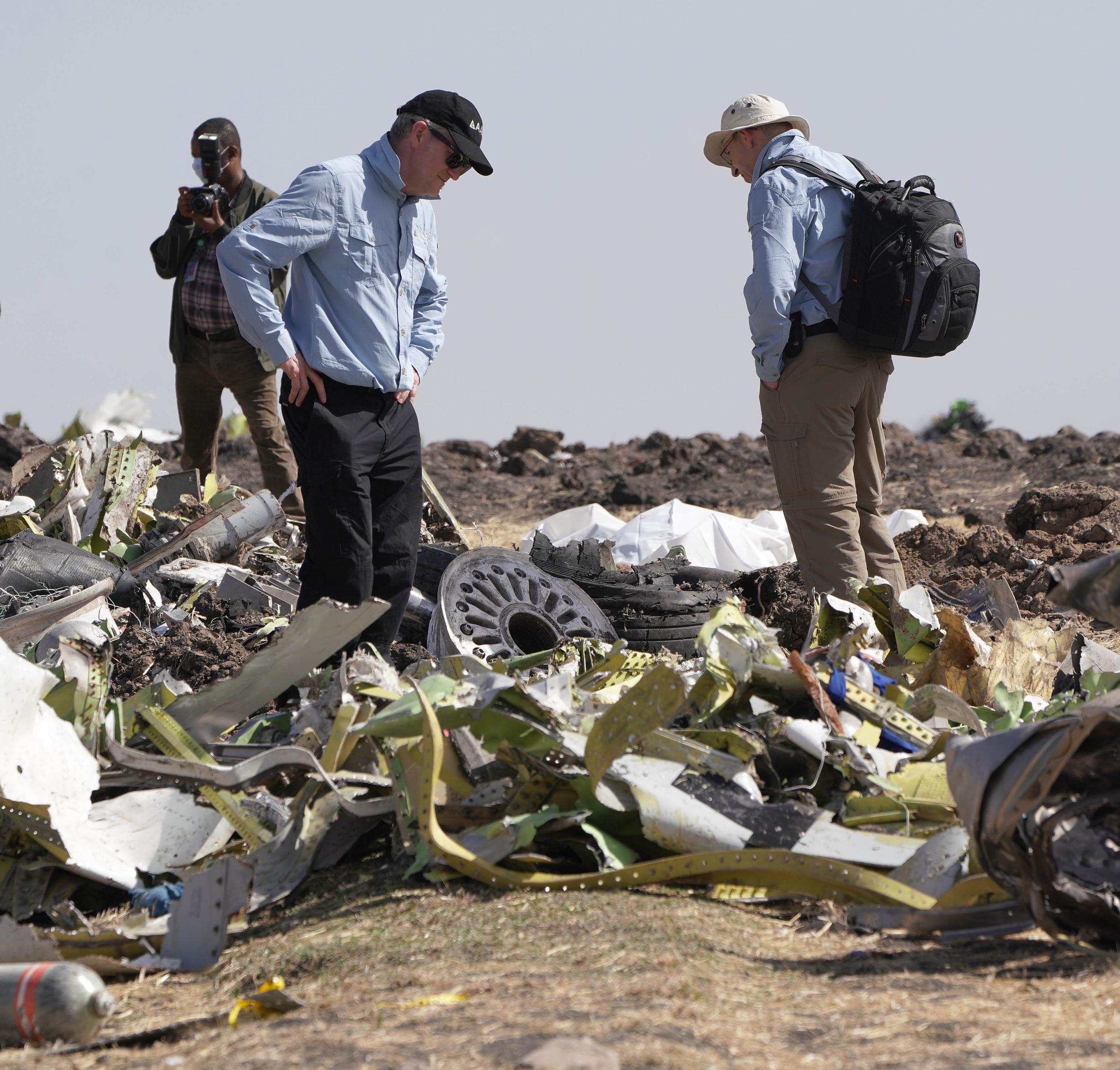 Investigators inspecting debris at the crash site of Ethiopian Airlines flight 302 in March